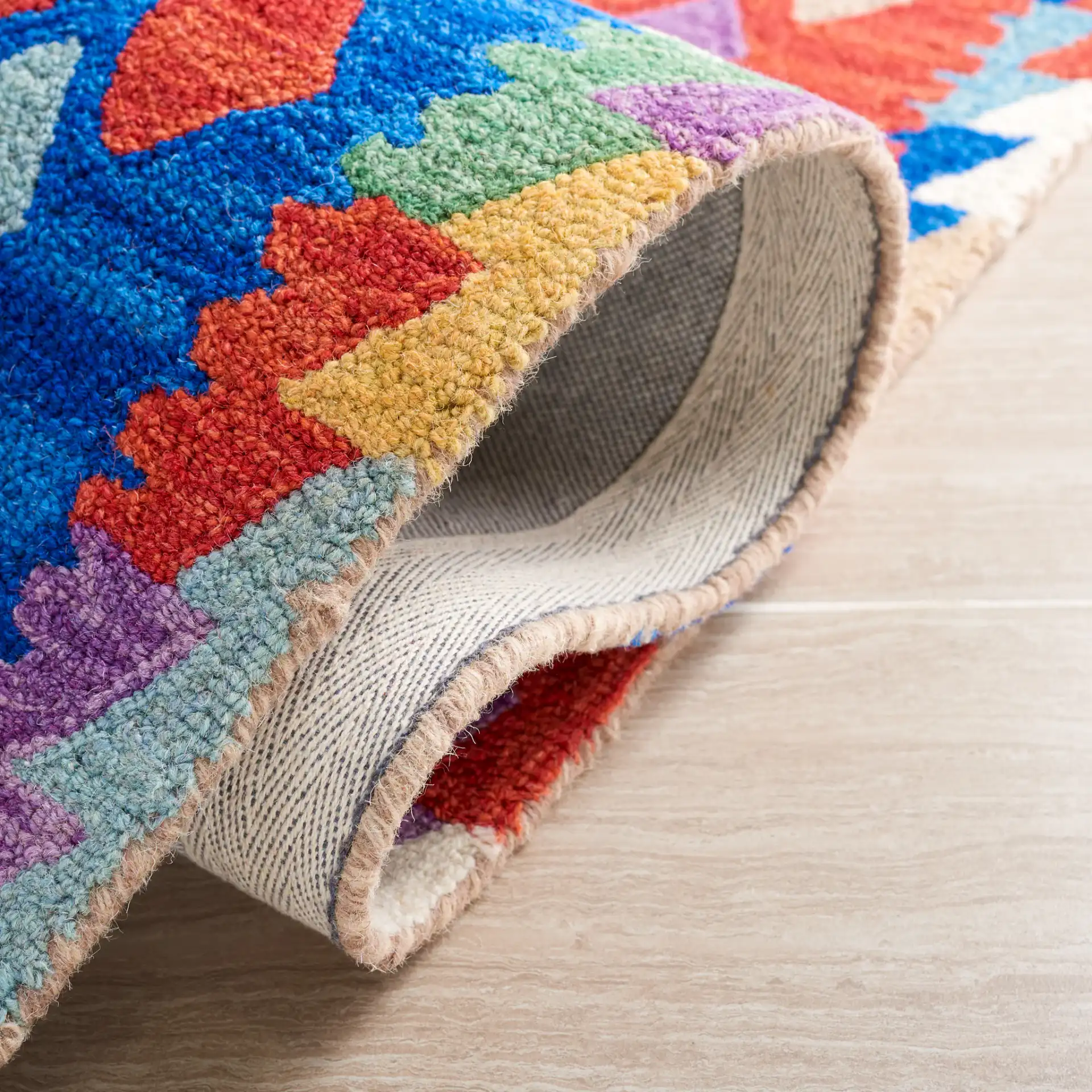 Aspen Patchwork Diamond Hand-Tufted Wool Rug in Red / Blue in a styled room