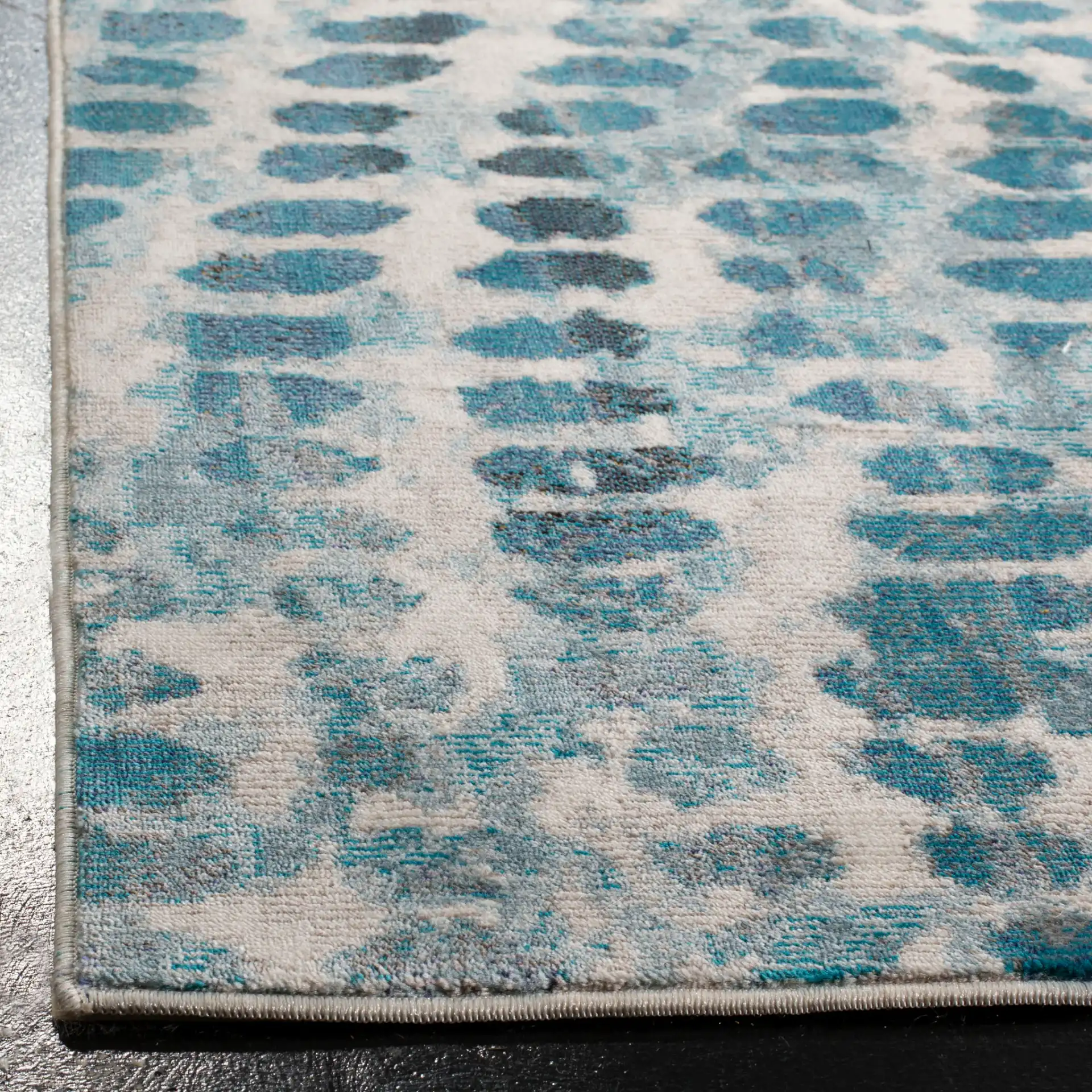 Aria Dotted Wave Rug in Cream / Teal in a styled room