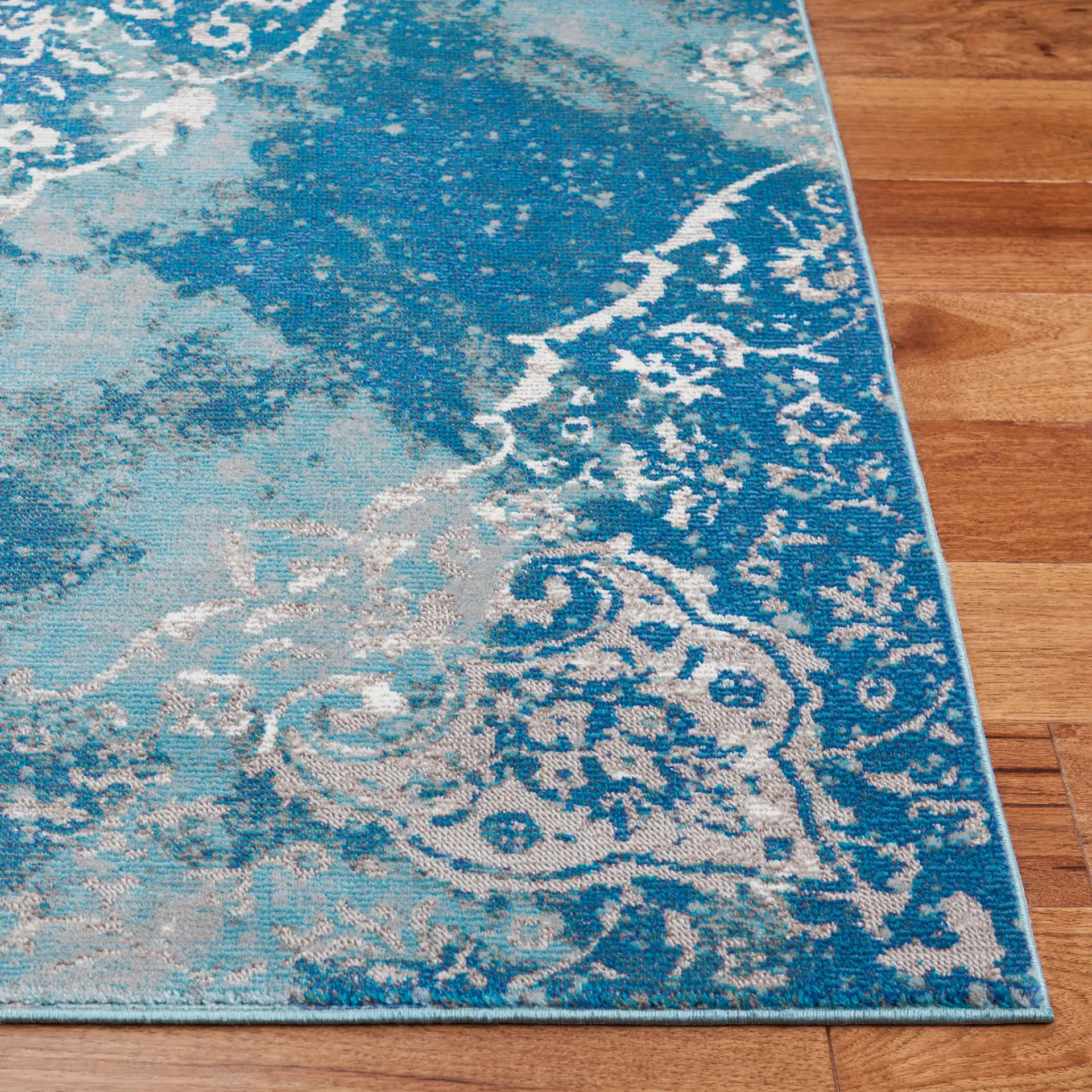 Aria Distressed Rosette Medallion Rug in Light Blue / Ivory in a styled room