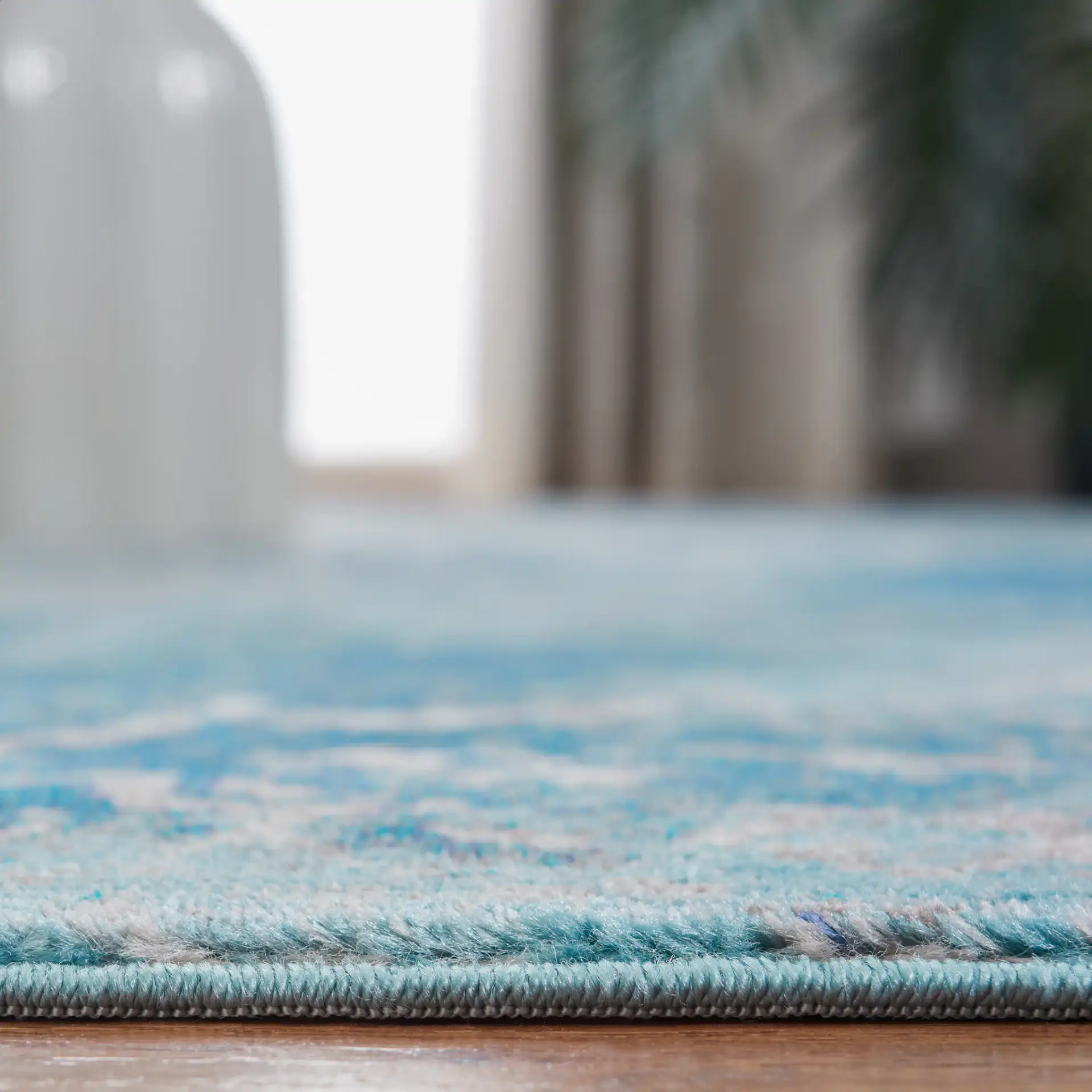 Aria Distressed Rosette Medallion Rug in Light Blue / Ivory in a styled room