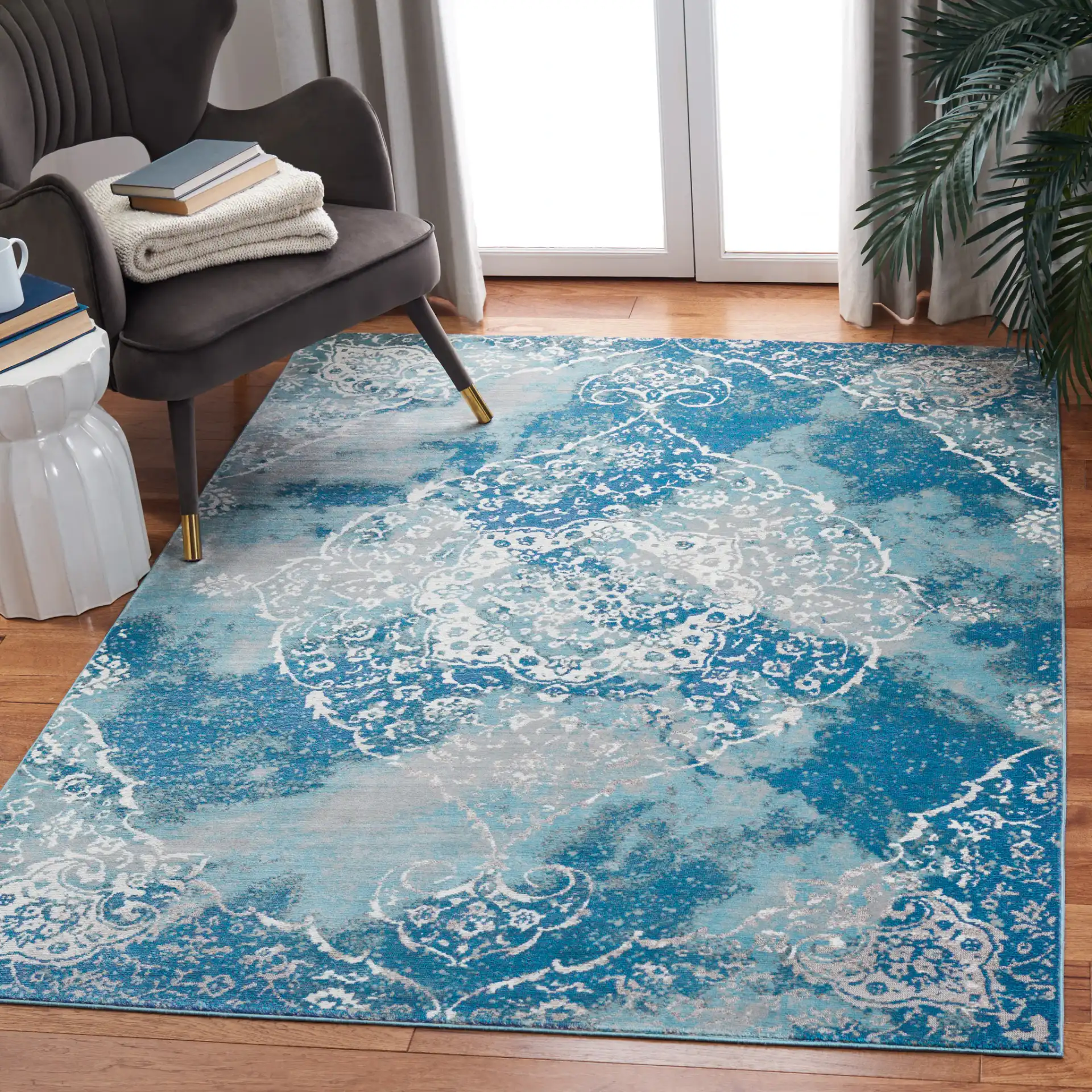 Aria Distressed Rosette Medallion Rug in Light Blue / Ivory in a styled room