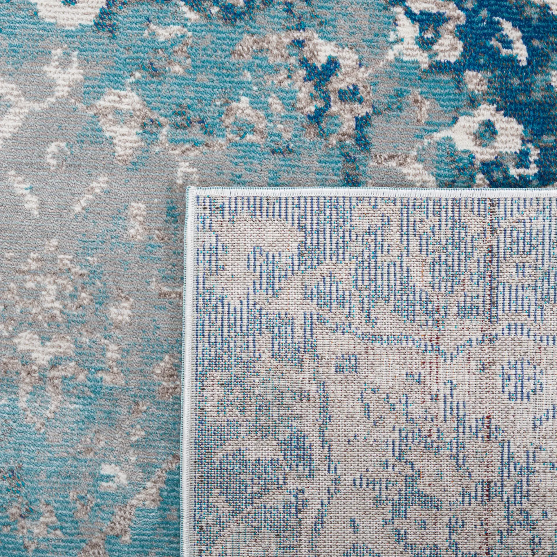 Aria Distressed Rosette Medallion Rug in Light Blue / Ivory in a styled room