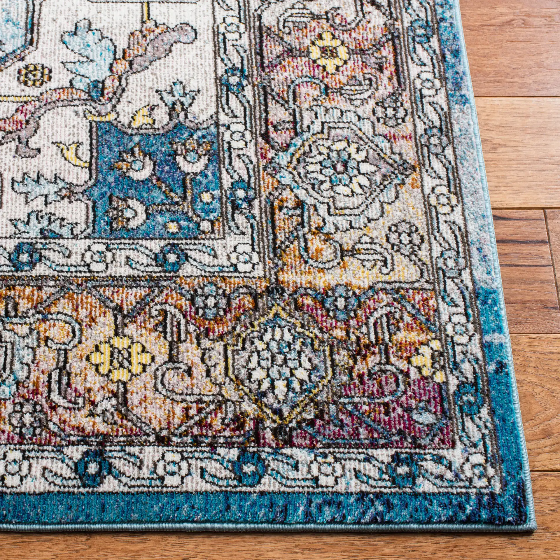 Aria Stepped Medallion Rug in Turquoise / Light Orange in a styled room