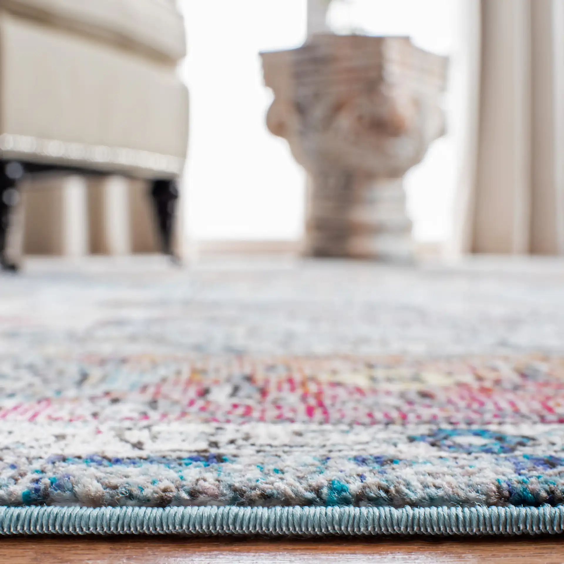Aria Stepped Medallion Rug in Turquoise / Light Orange in a styled room