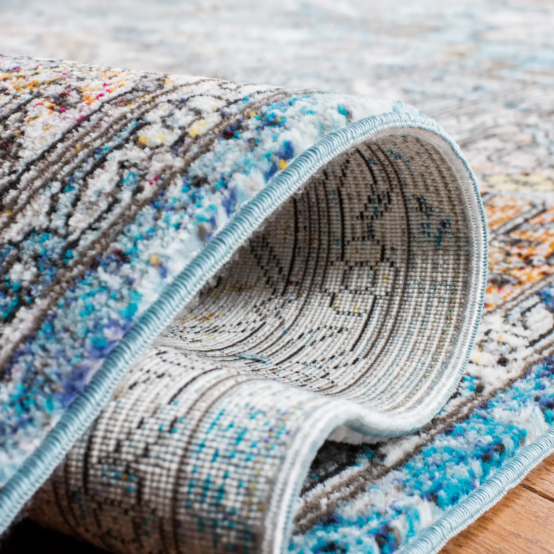Aria Stepped Medallion Rug in Turquoise / Light Orange in a styled room