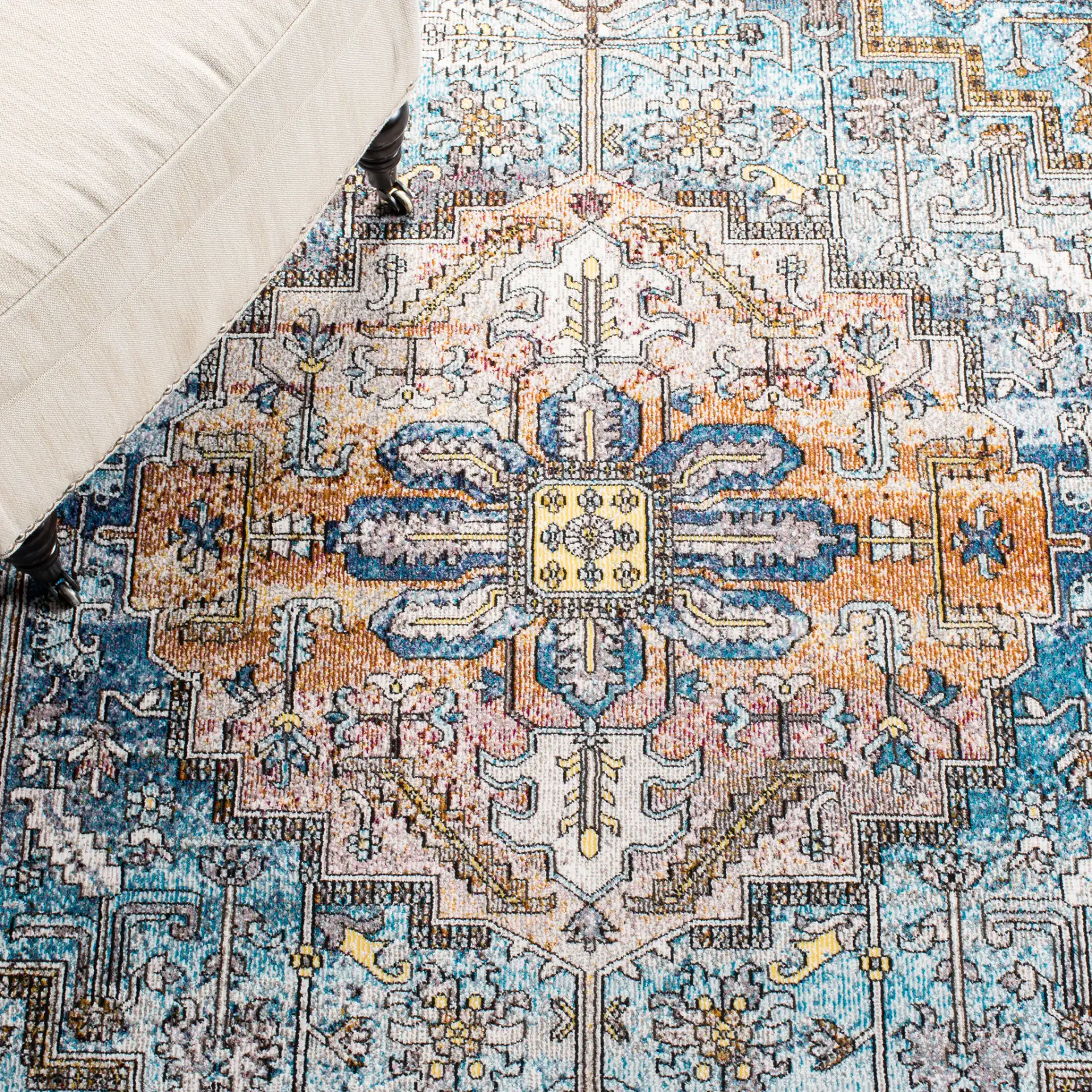 Aria Stepped Medallion Rug in Turquoise / Light Orange in a styled room