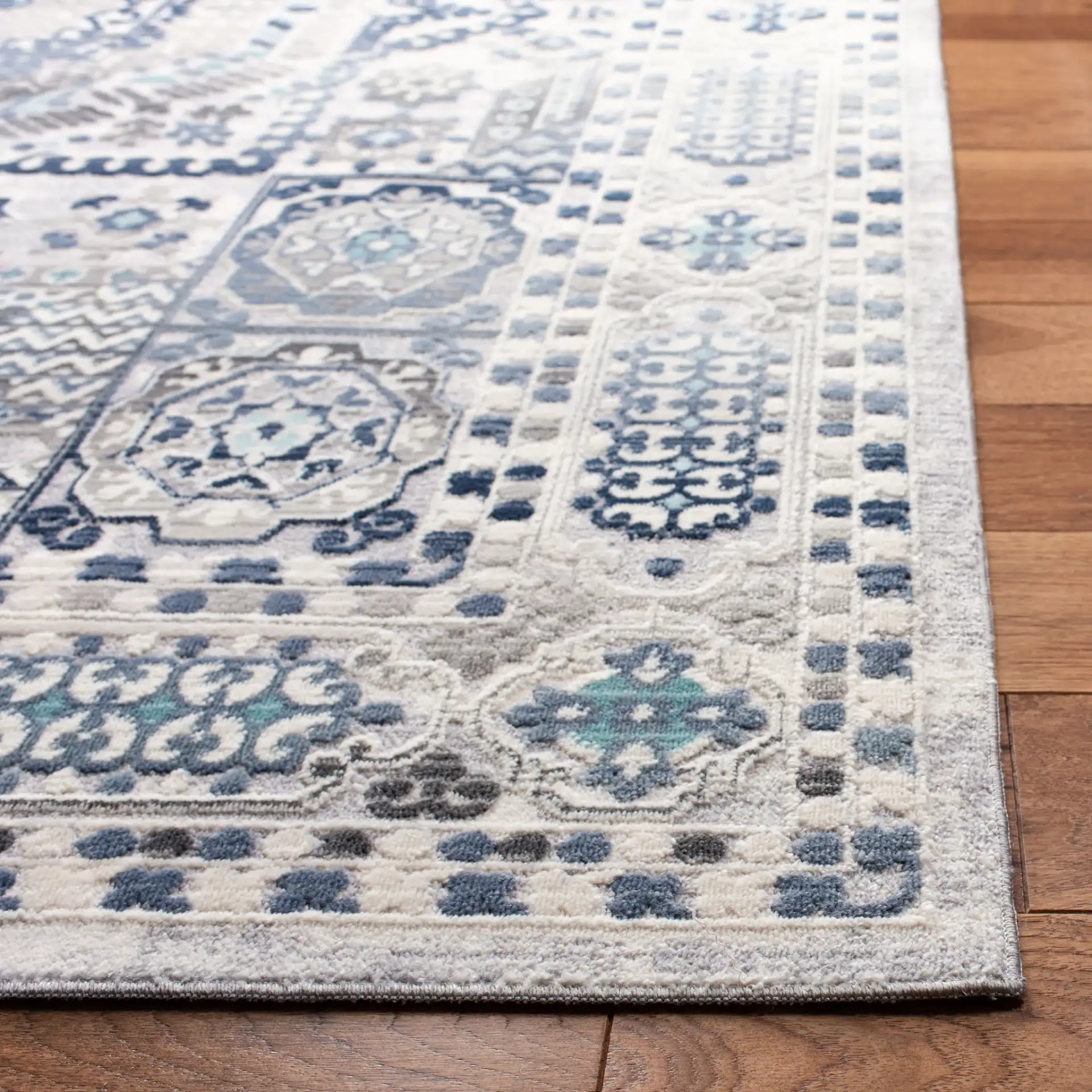 Aria Geometric Medallion Rug in Gray / Cream in a styled room
