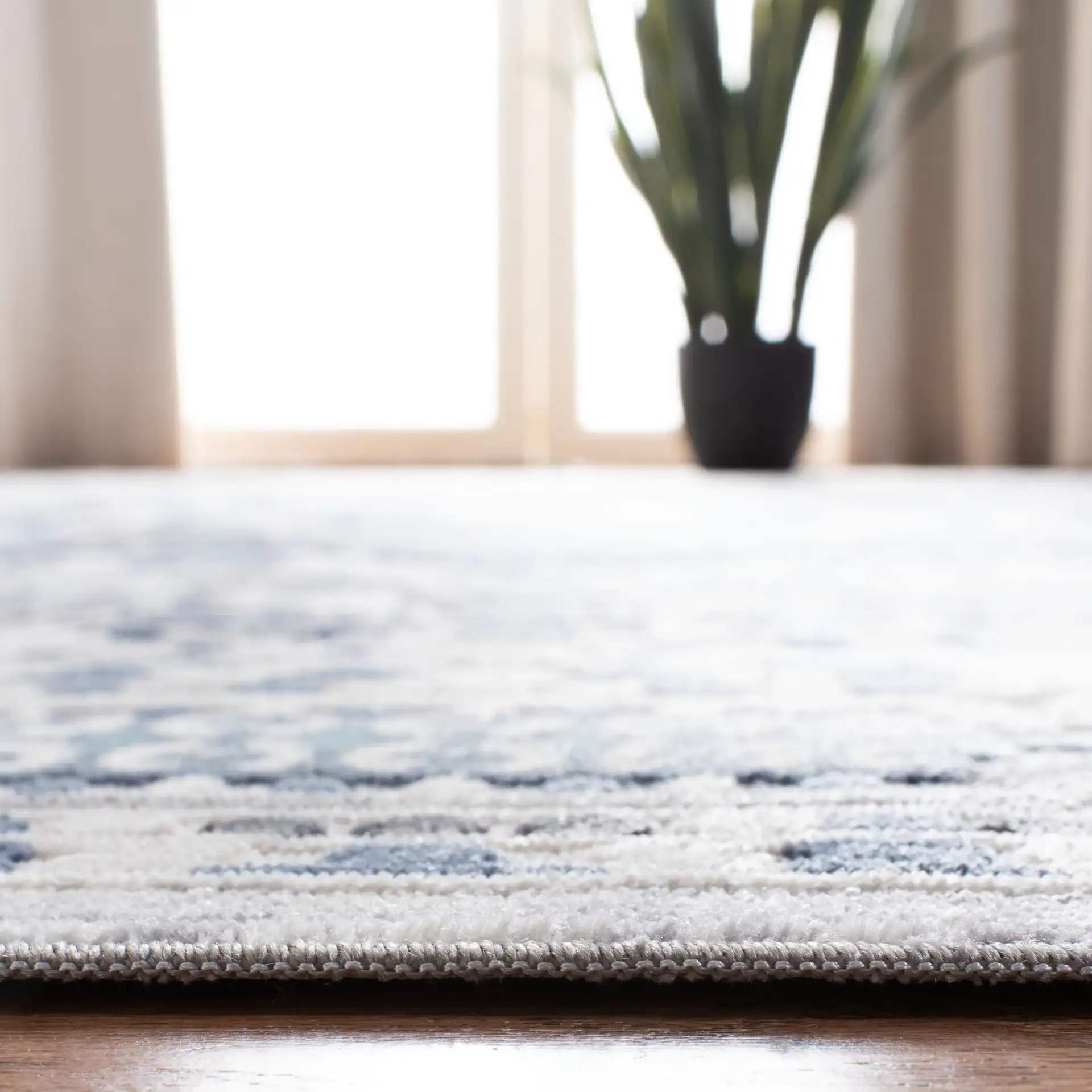 Aria Geometric Medallion Rug in Gray / Cream in a styled room