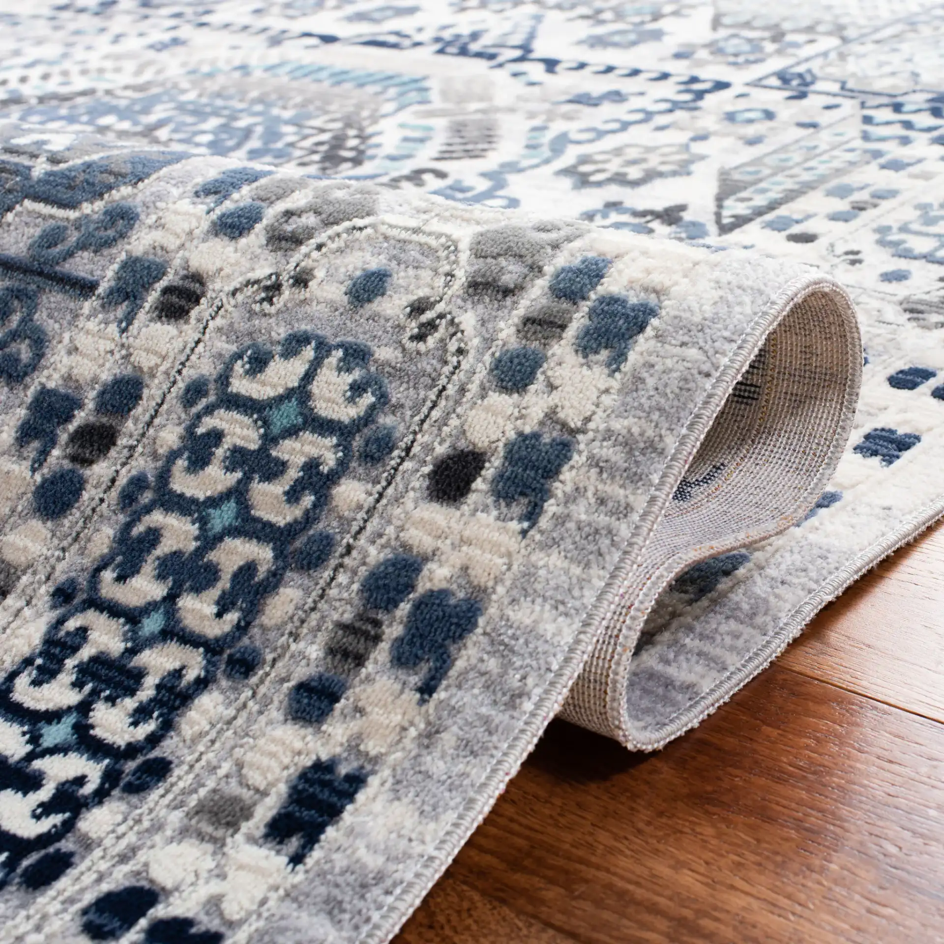 Aria Geometric Medallion Rug in Gray / Cream in a styled room