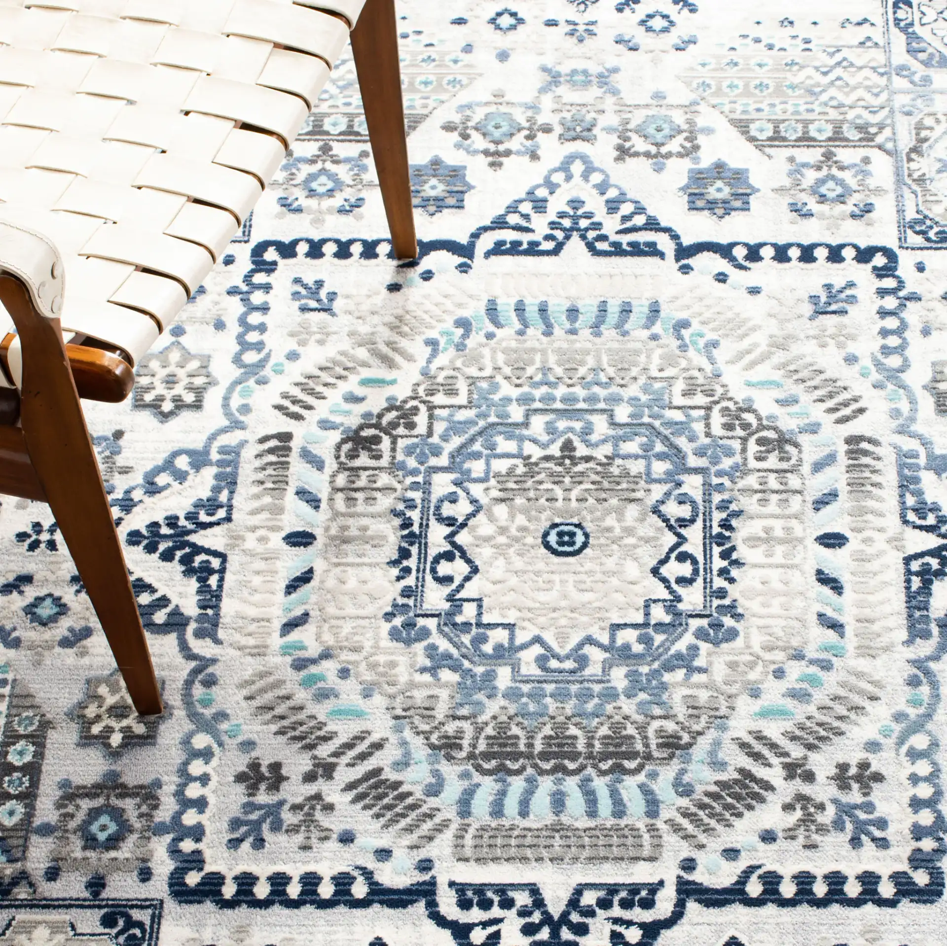 Aria Geometric Medallion Rug in Gray / Cream in a styled room