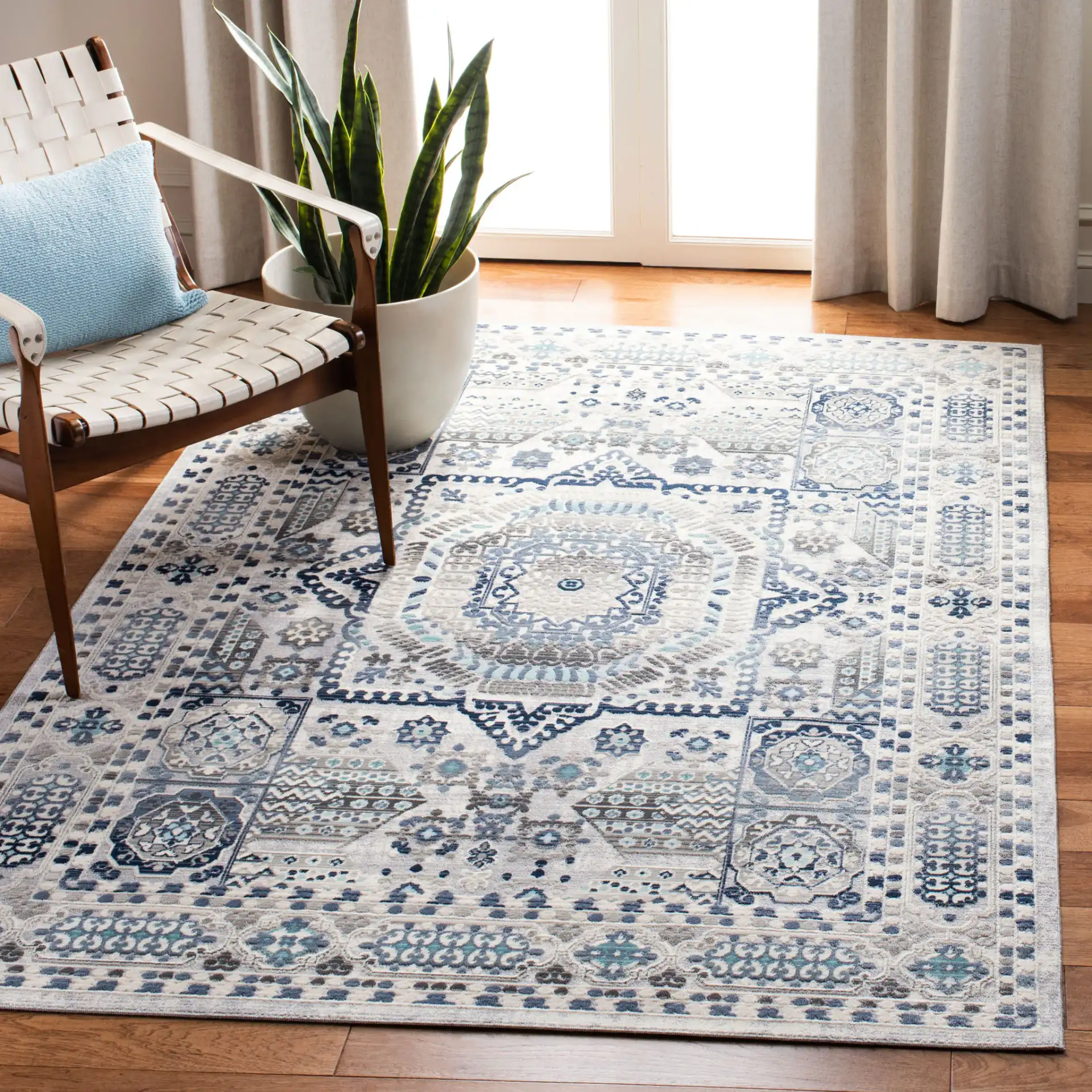 Aria Geometric Medallion Rug in Gray / Cream in a styled room