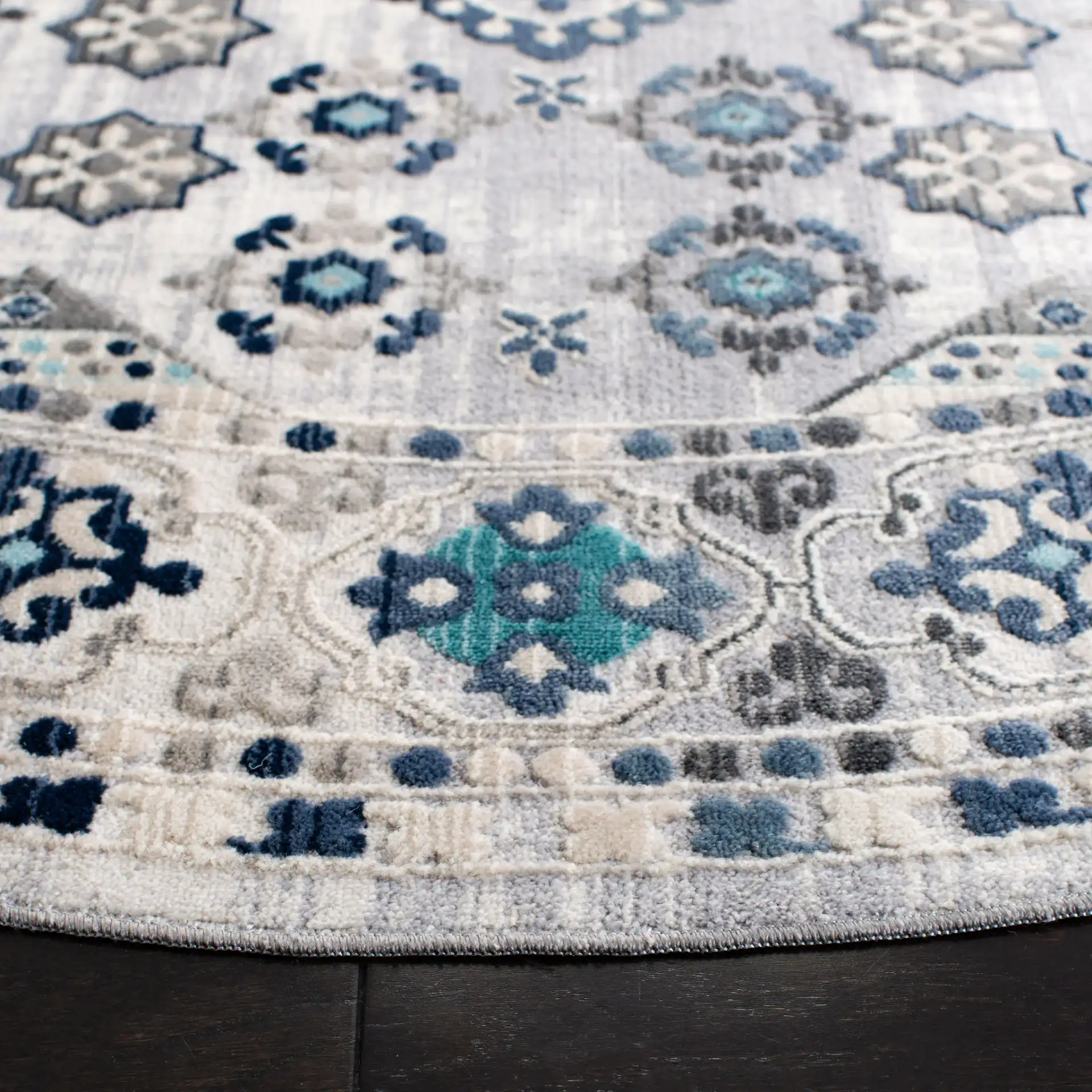 Aria Geometric Medallion Rug in Gray / Cream in a styled room