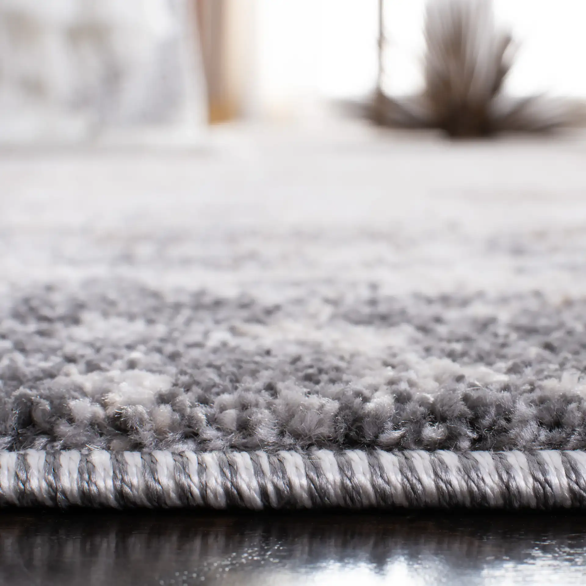 Aston Bordered Abstract Rug in Gray / Ivory in a styled room