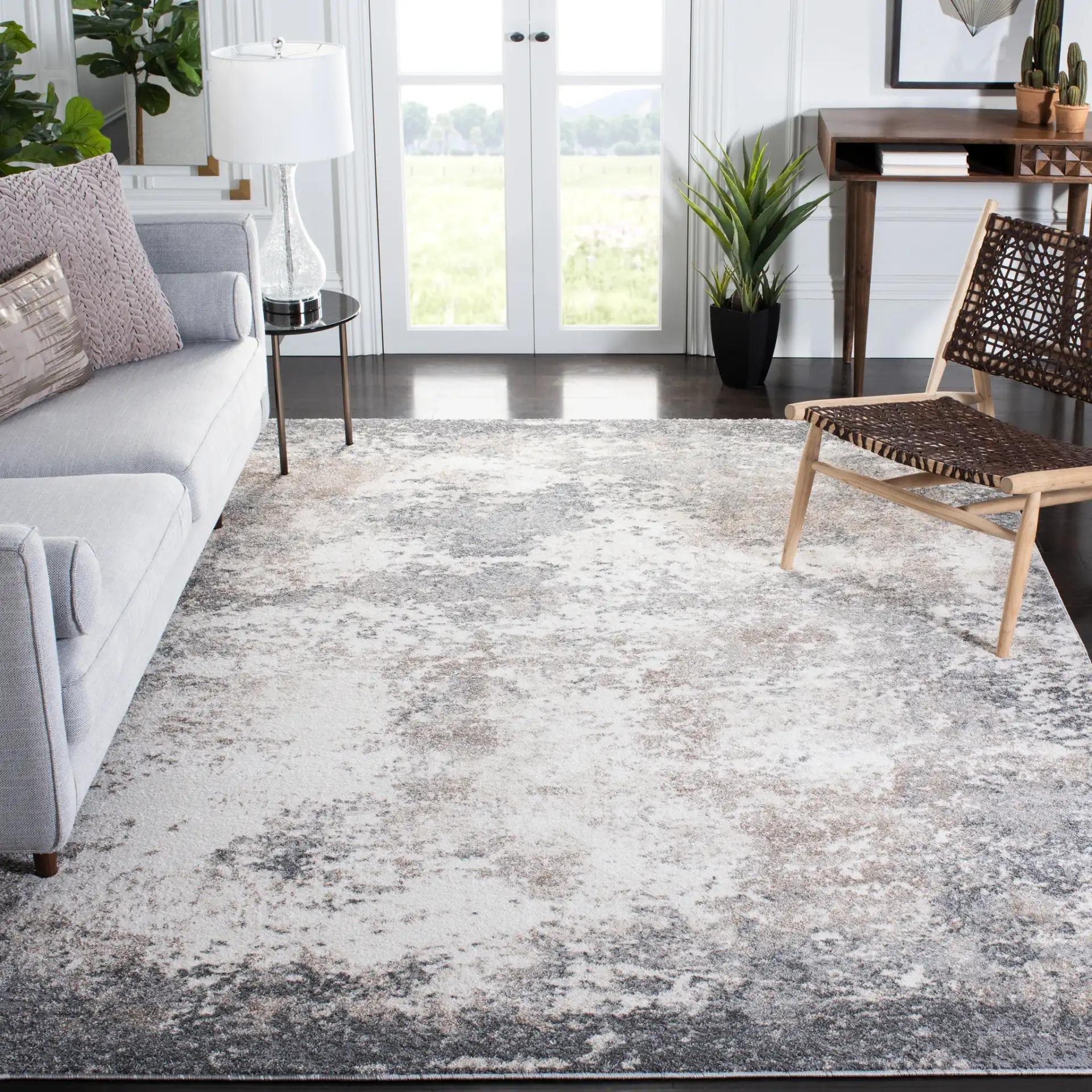 Aston Bordered Abstract Rug in Gray / Ivory in a styled room