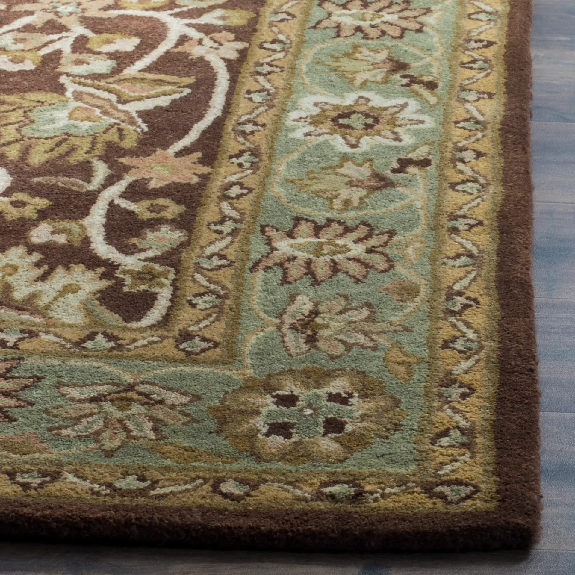 Antiquity Palmette Bordered Hand-Tufted Wool Rug in Chocolate / Blue in a styled room