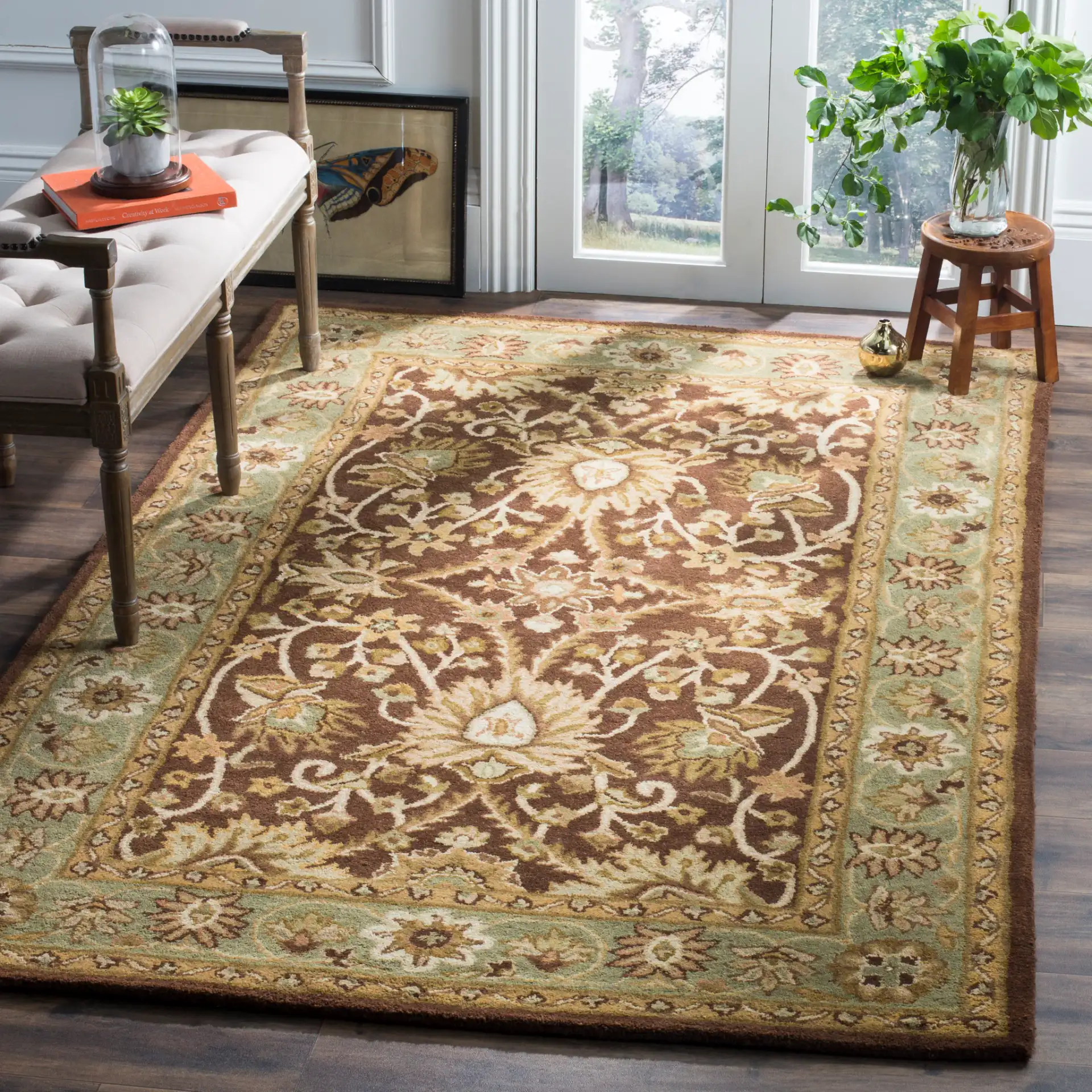 Antiquity Palmette Bordered Hand-Tufted Wool Rug in Chocolate / Blue in a styled room