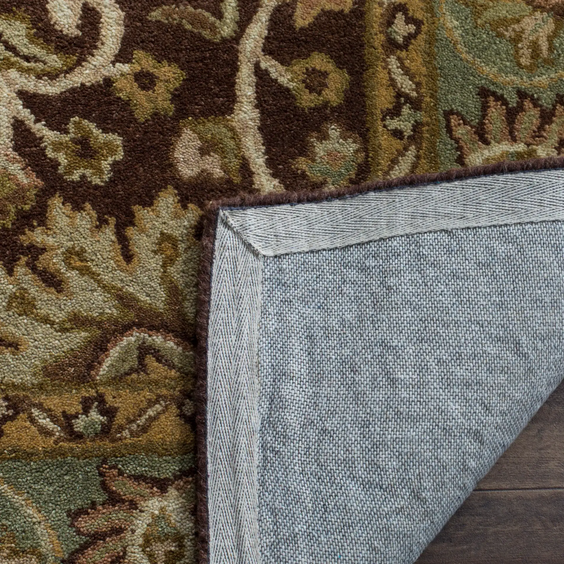 Antiquity Palmette Bordered Hand-Tufted Wool Rug in Chocolate / Blue in a styled room