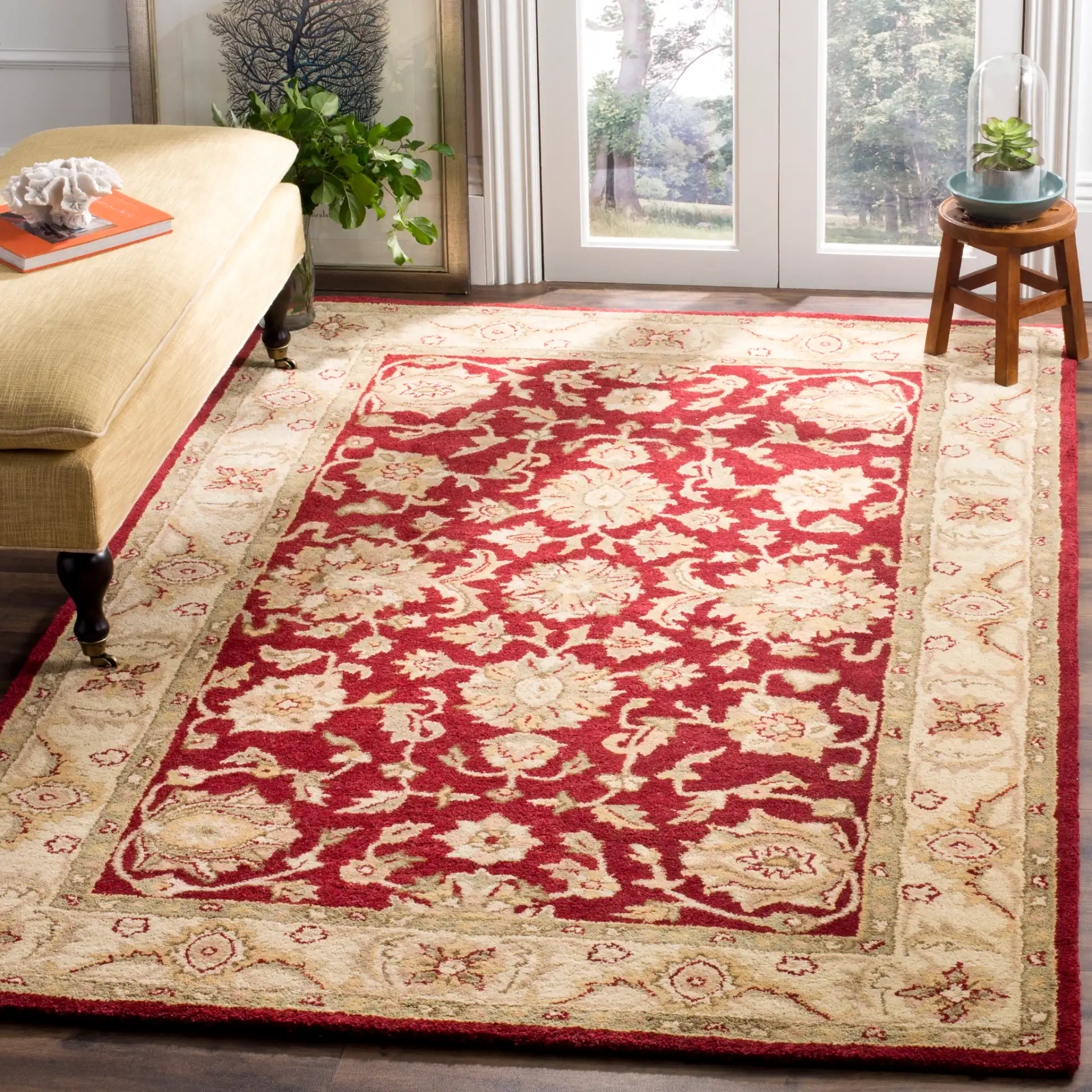 Antiquity Floral Border Hand-Tufted Wool Rug in Red / Gold in a styled room