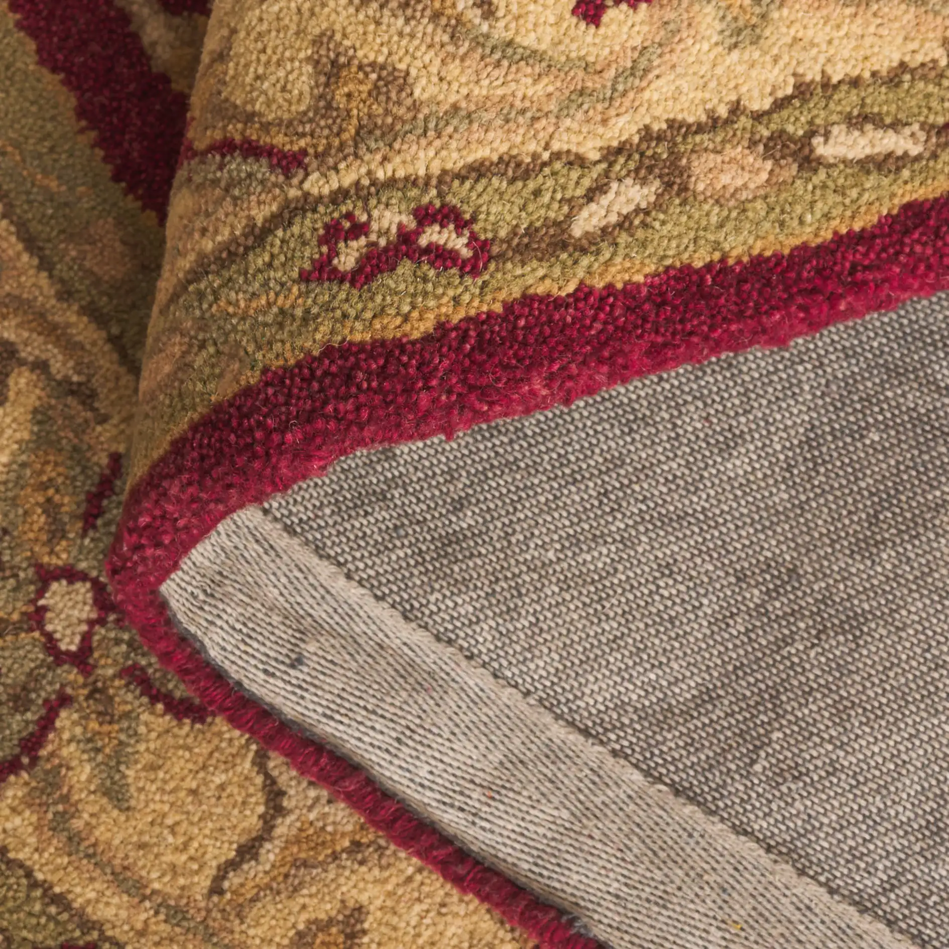 Antiquity Floral Border Hand-Tufted Wool Rug in Red / Gold in a styled room