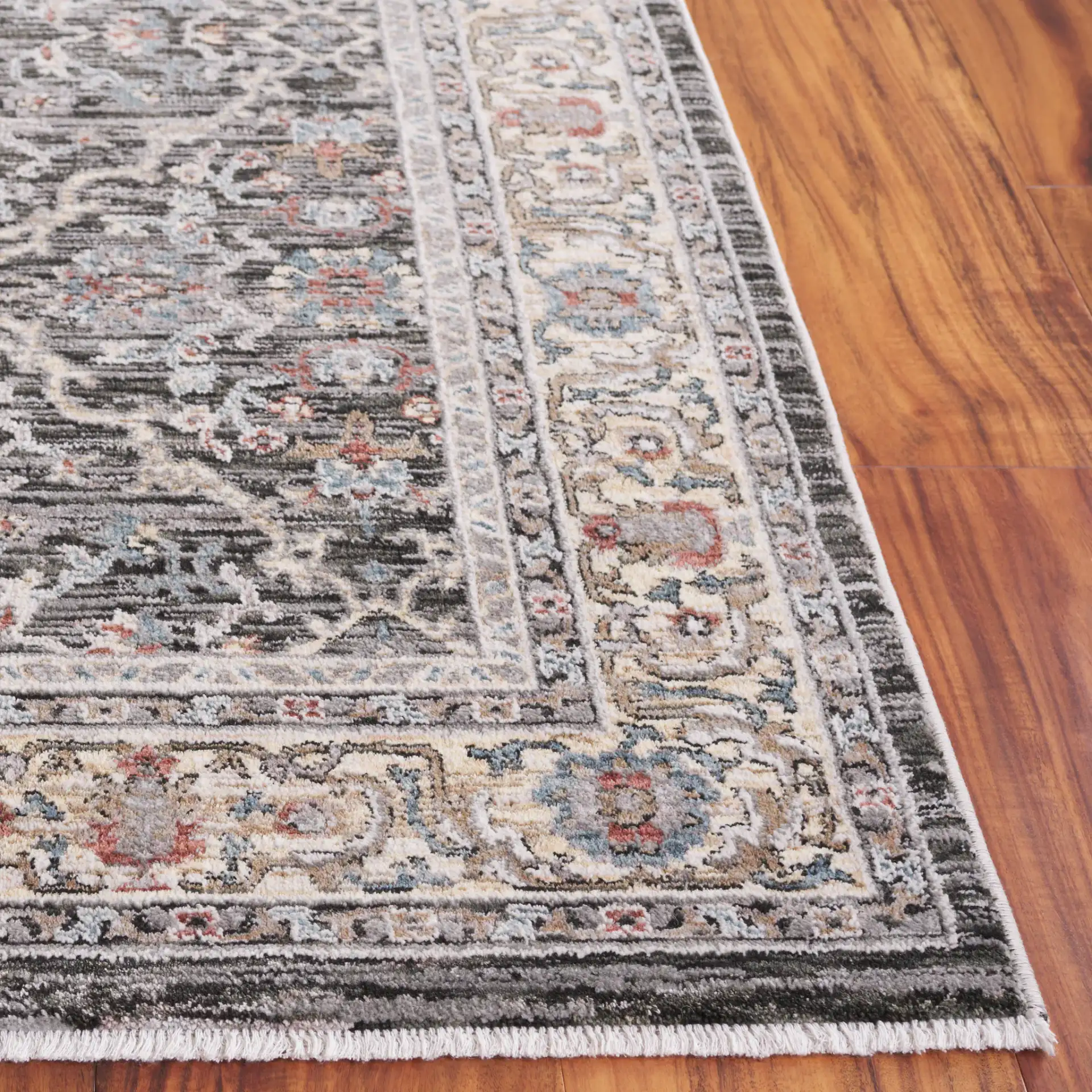 Artifact Bordered Floral Rug in Charcoal / Gray in a styled room