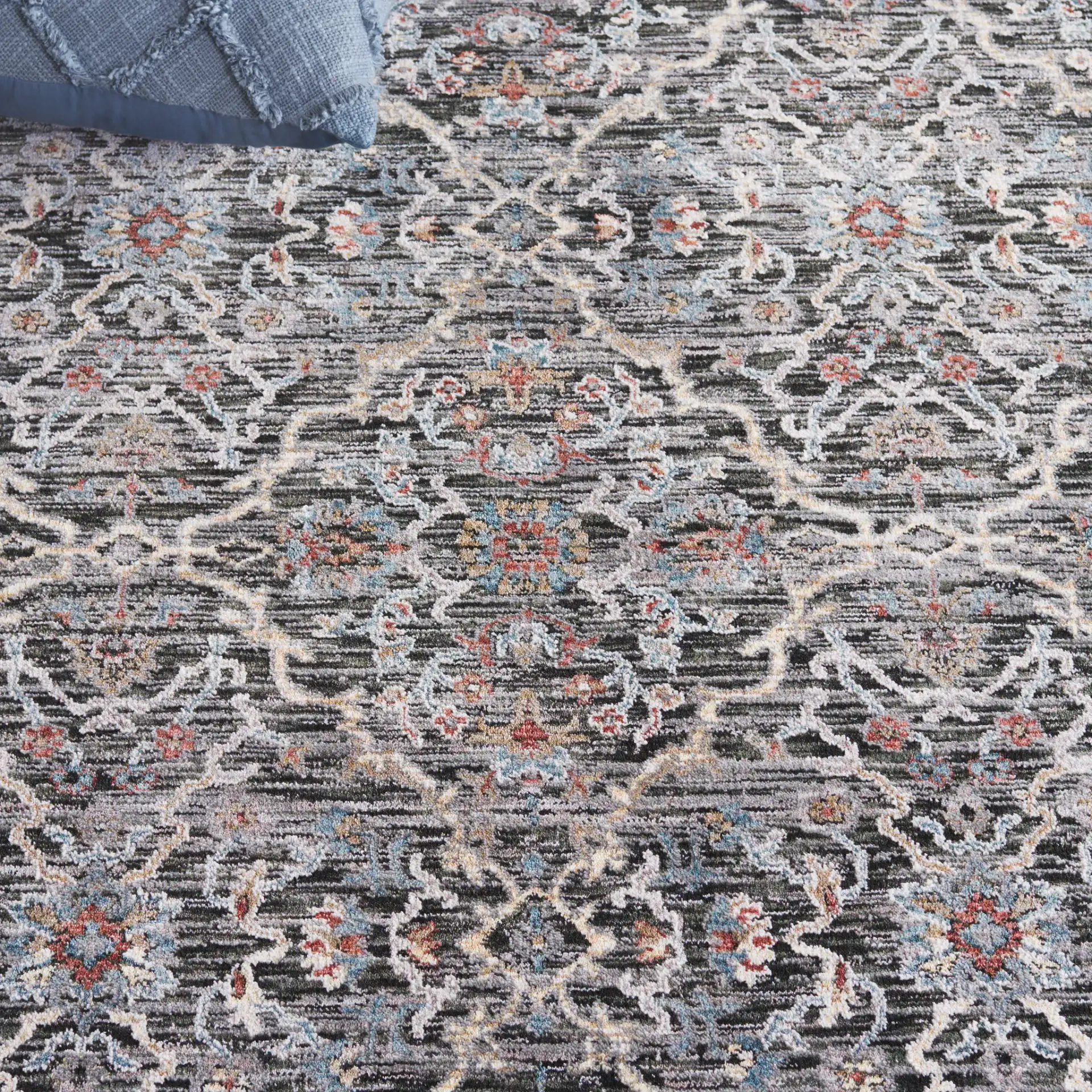 Artifact Bordered Floral Rug in Charcoal / Gray in a styled room