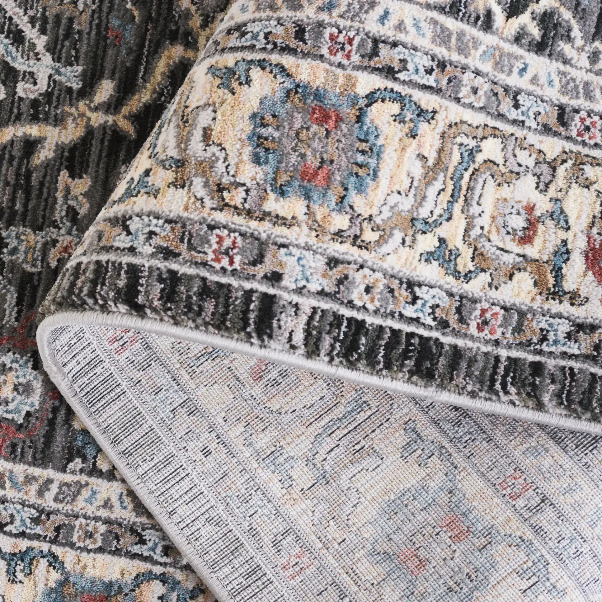 Artifact Bordered Floral Rug in Charcoal / Gray in a styled room