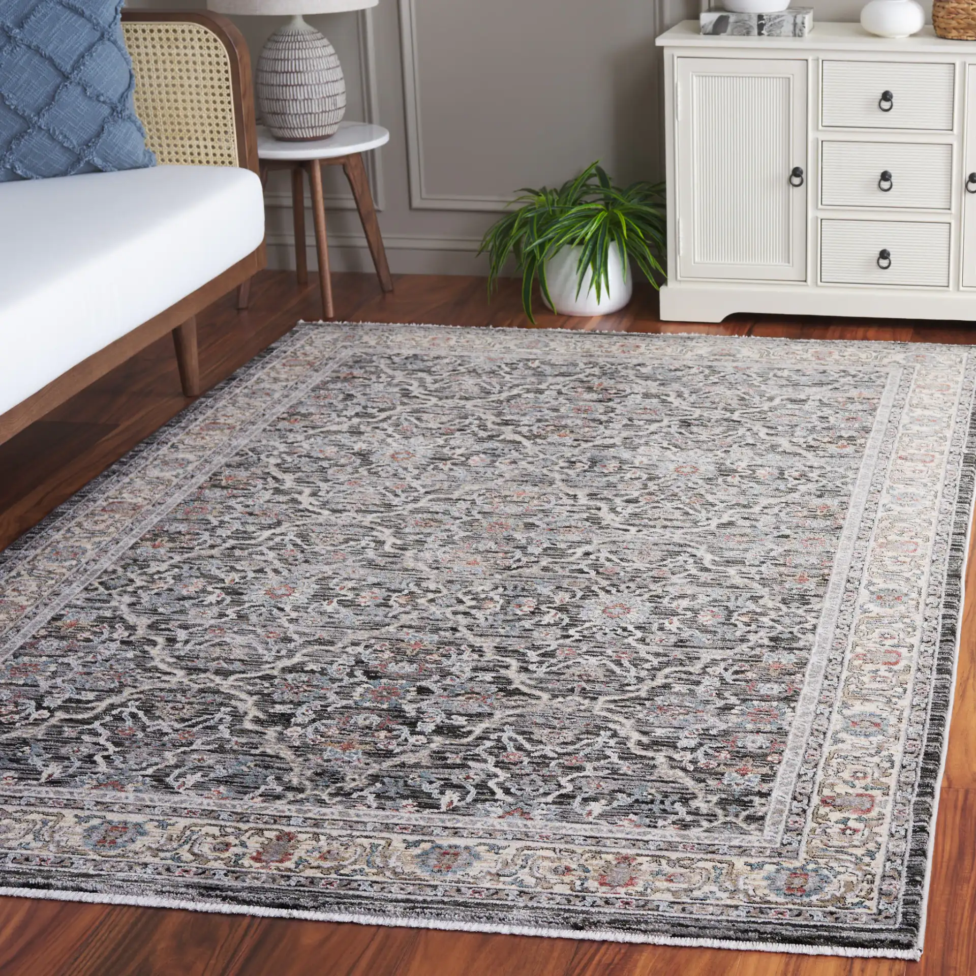 Artifact Bordered Floral Rug in Charcoal / Gray in a styled room