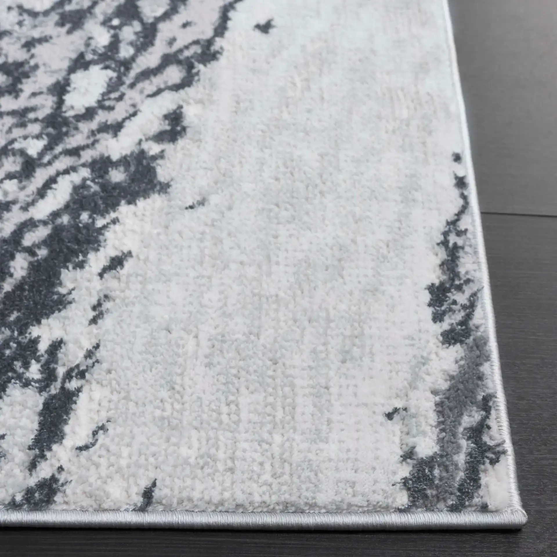 Aura Marble Abstract Rug in Ivory / Dark Gray in a styled room