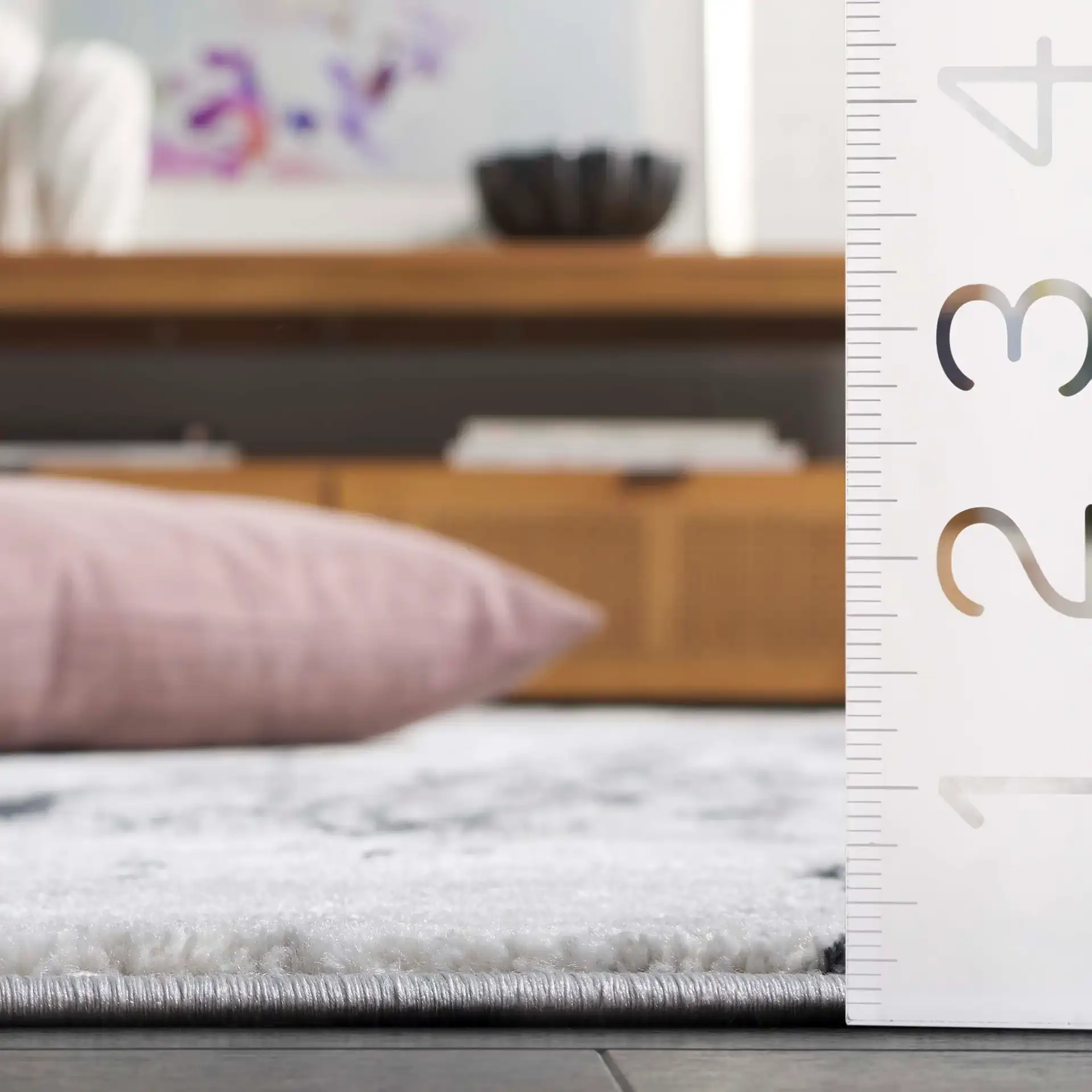 Aura Marble Abstract Rug in Ivory / Dark Gray in a styled room