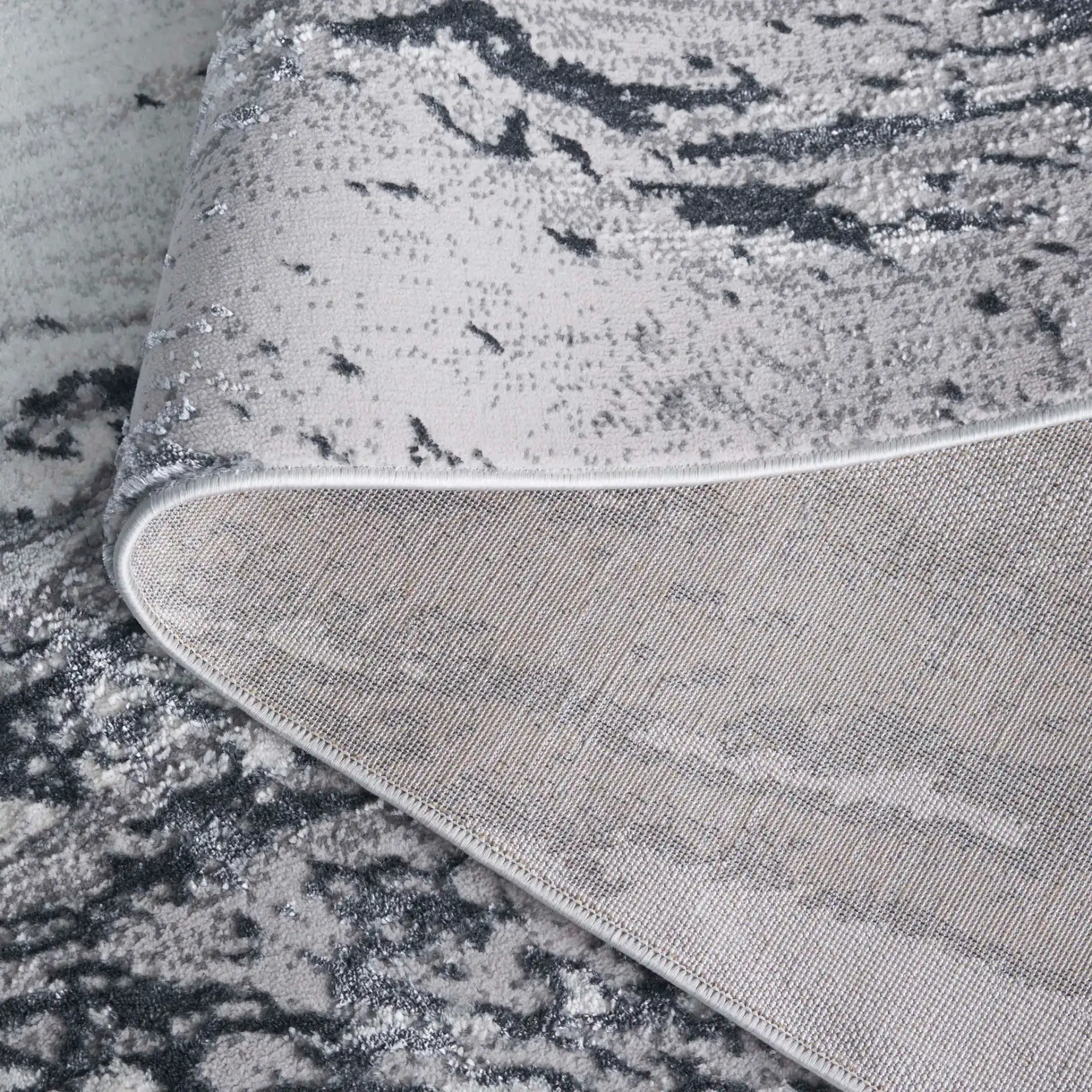 Aura Marble Abstract Rug in Ivory / Dark Gray in a styled room