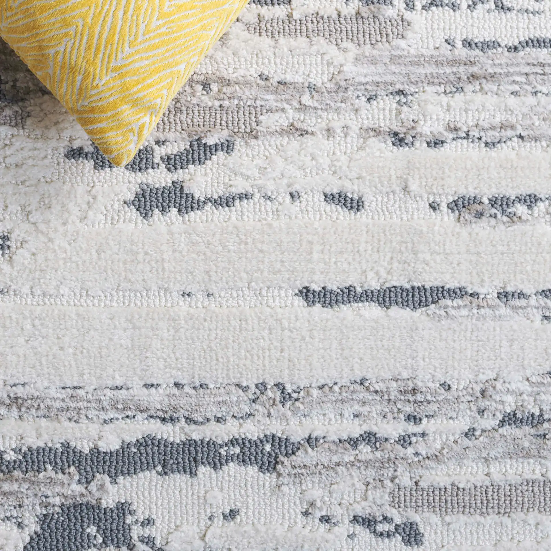 Audrey Striated Abstract Rug in Gray / Beige in a styled room