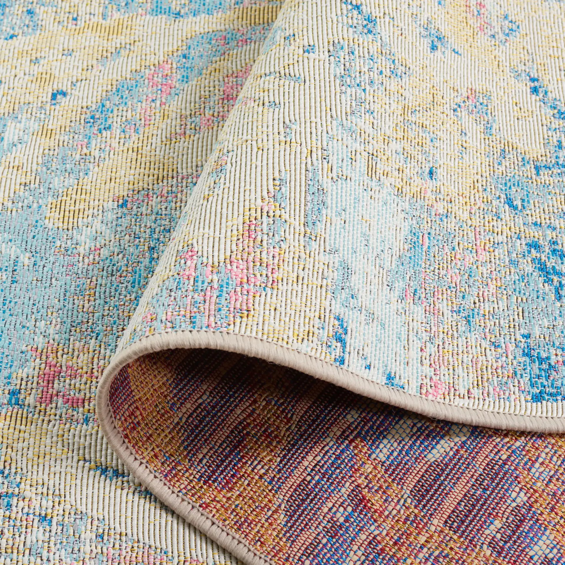 Barbados Distressed Palm Outdoor Rug in Light Blue / Ivory in a styled room