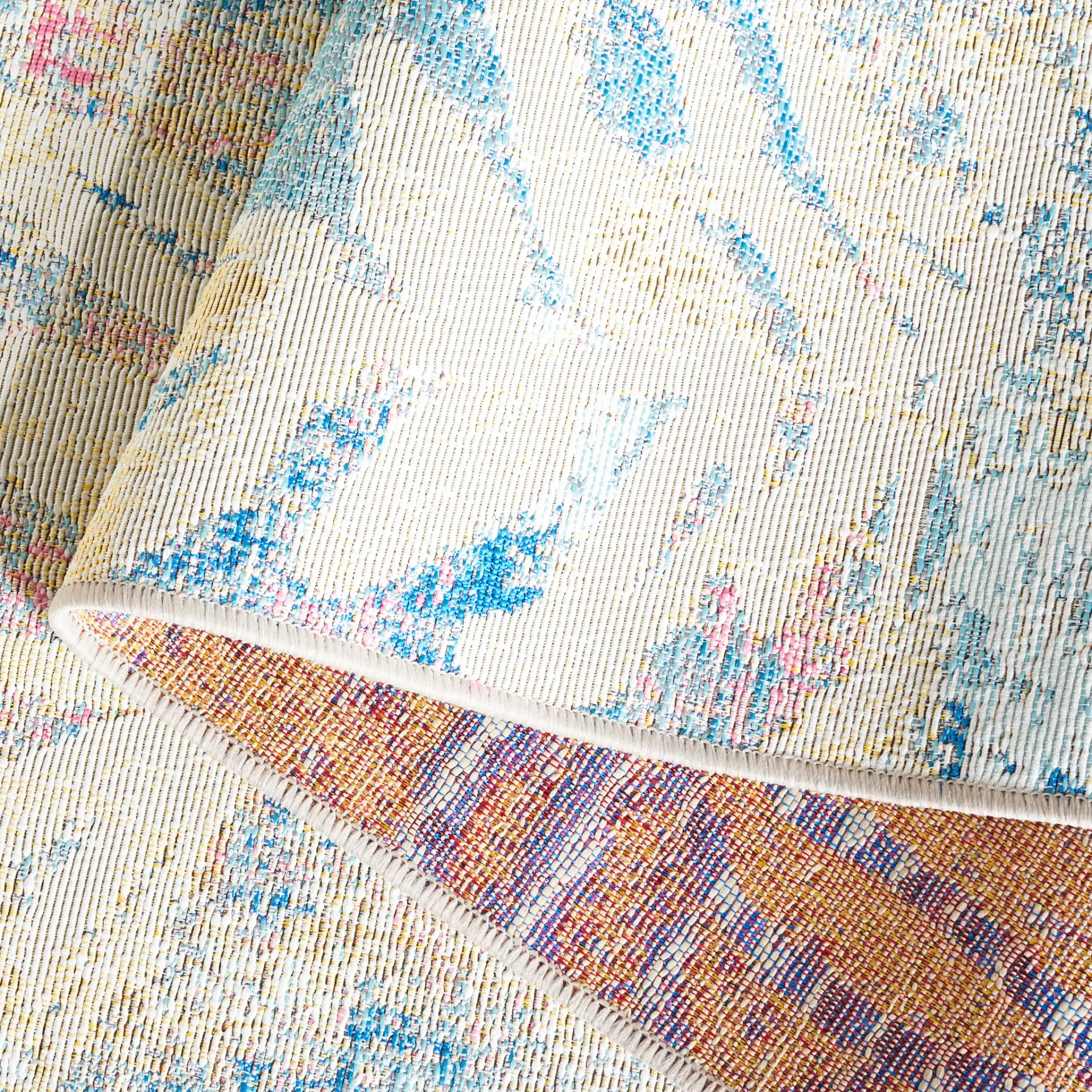 Barbados Distressed Palm Outdoor Rug in Light Blue / Ivory in a styled room