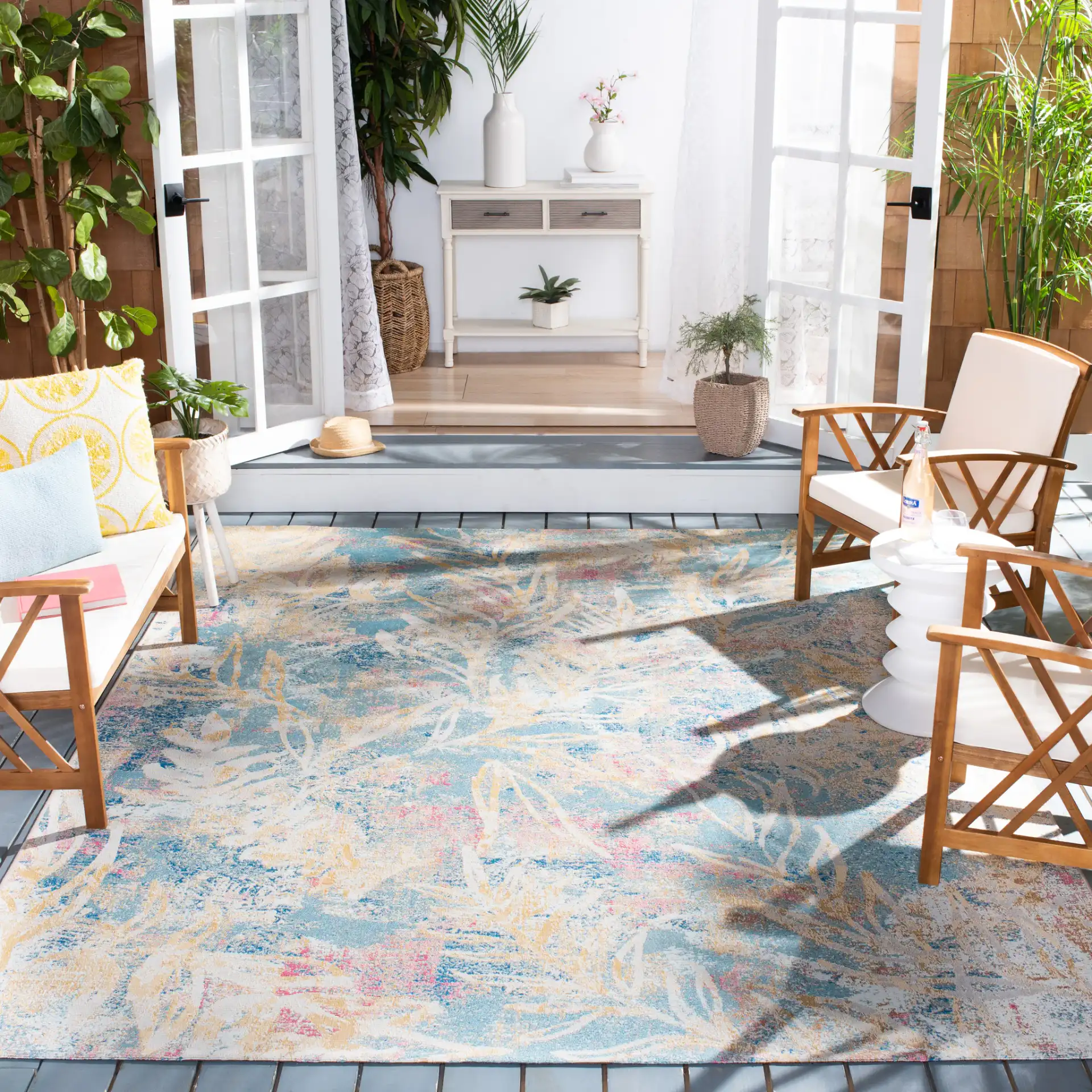 Barbados Distressed Palm Outdoor Rug in Light Blue / Ivory in a styled room