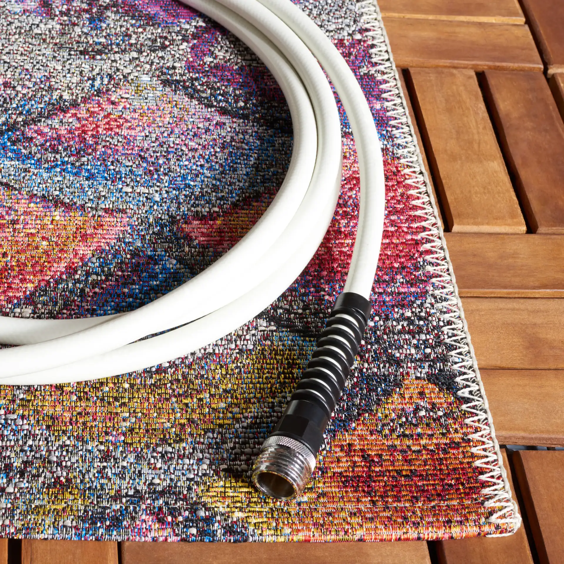 Barbados Scalloped Fan Outdoor Rug in Gray Purple / Blue Gold in a styled room