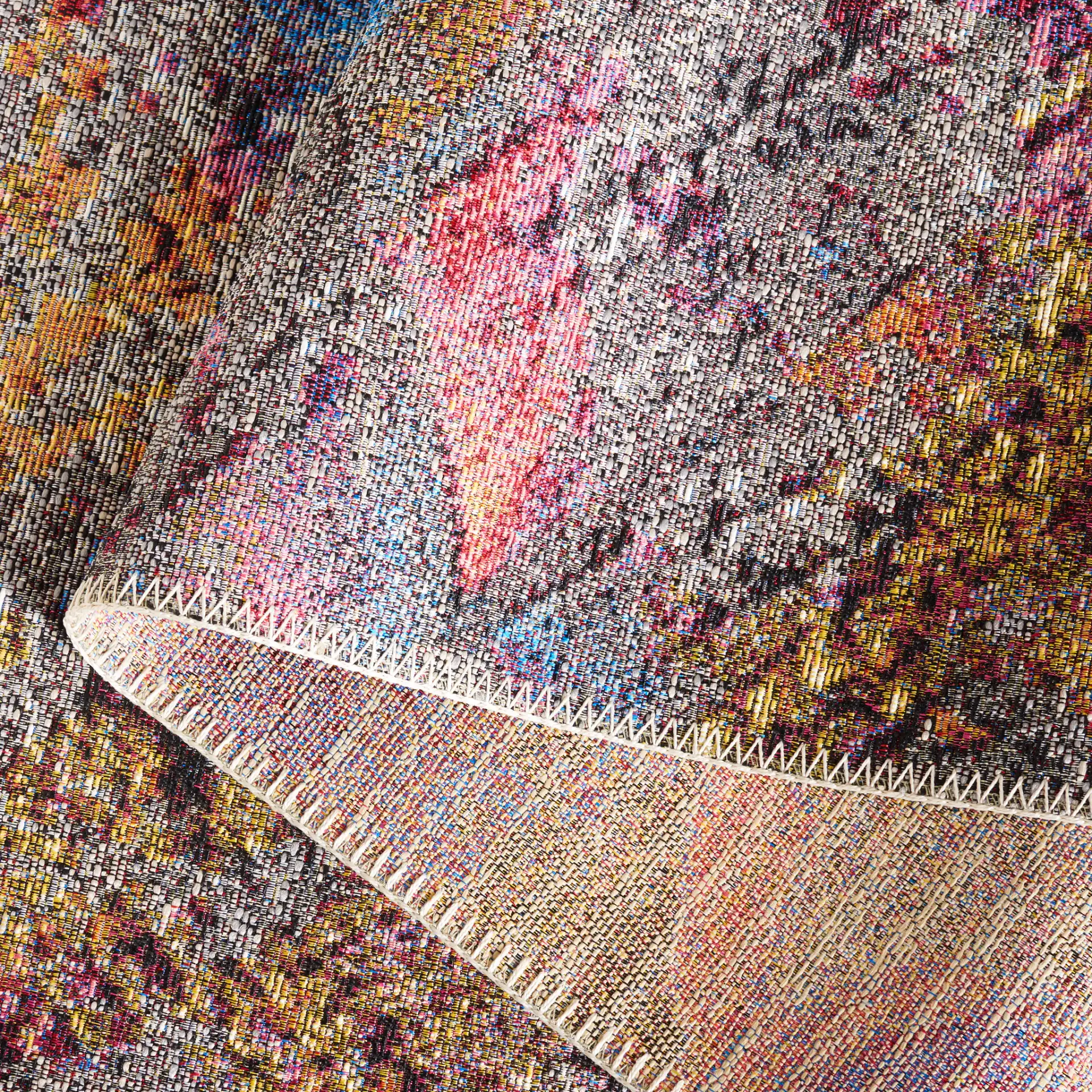 Barbados Scalloped Fan Outdoor Rug in Gray Purple / Blue Gold in a styled room