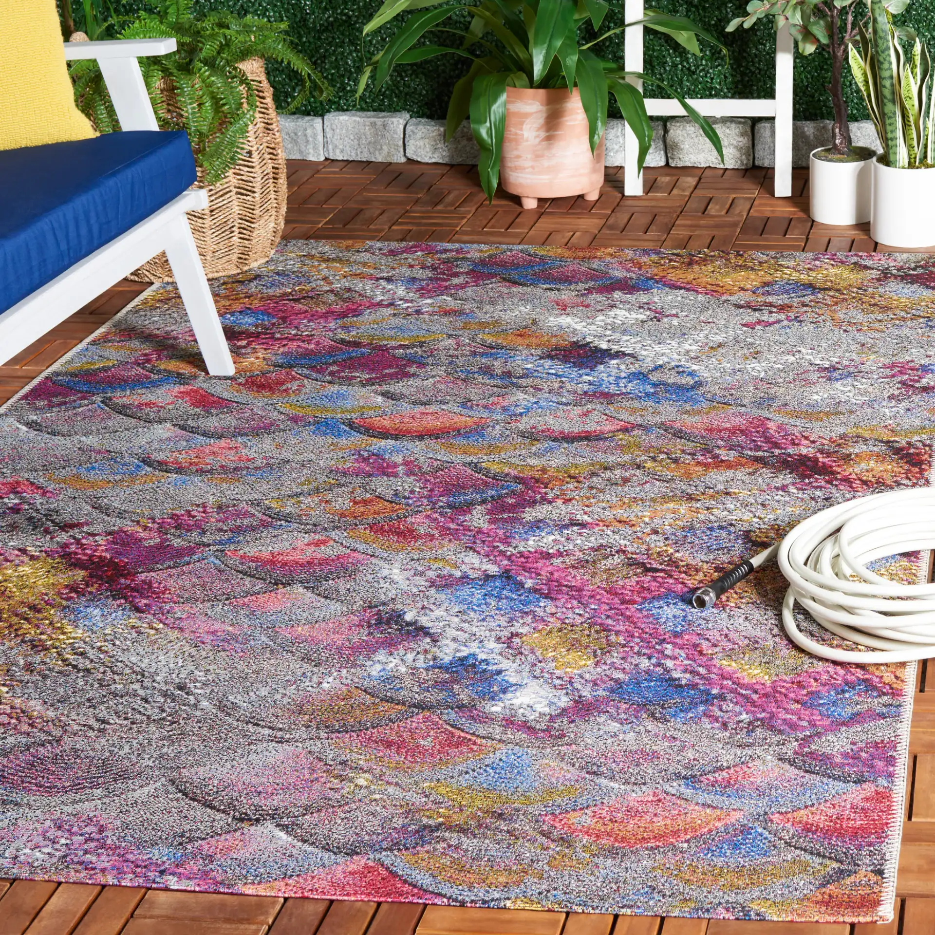 Barbados Scalloped Fan Outdoor Rug in Gray Purple / Blue Gold in a styled room