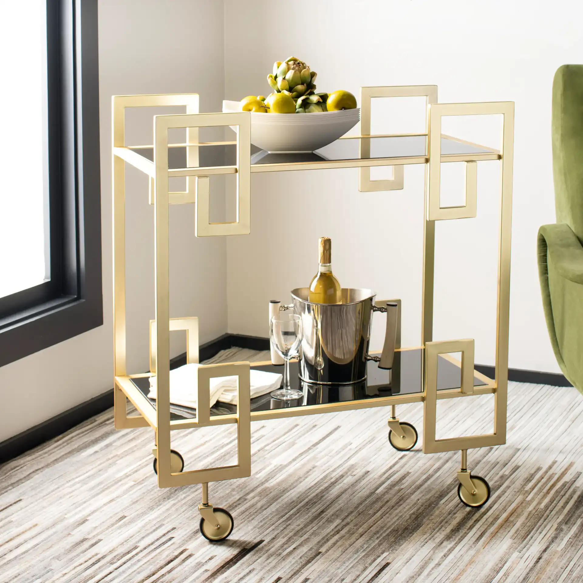 Eliza Two-Tier Bar Cart in Matte Brass / Clear in a styled room