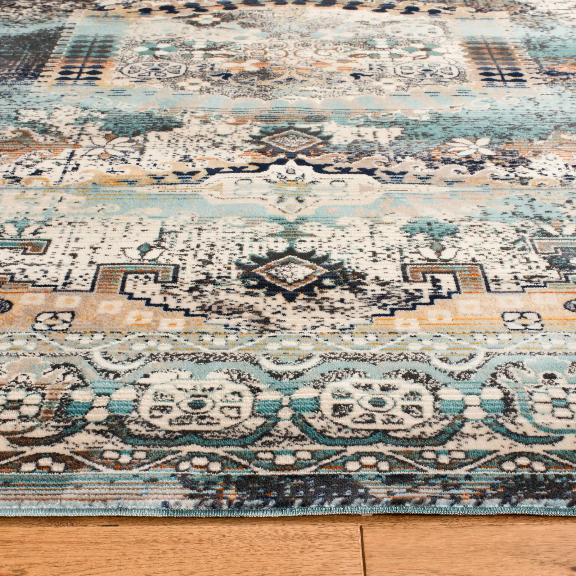 Baldwin Distressed Medallion Rug in Ivory / Teal in a styled room