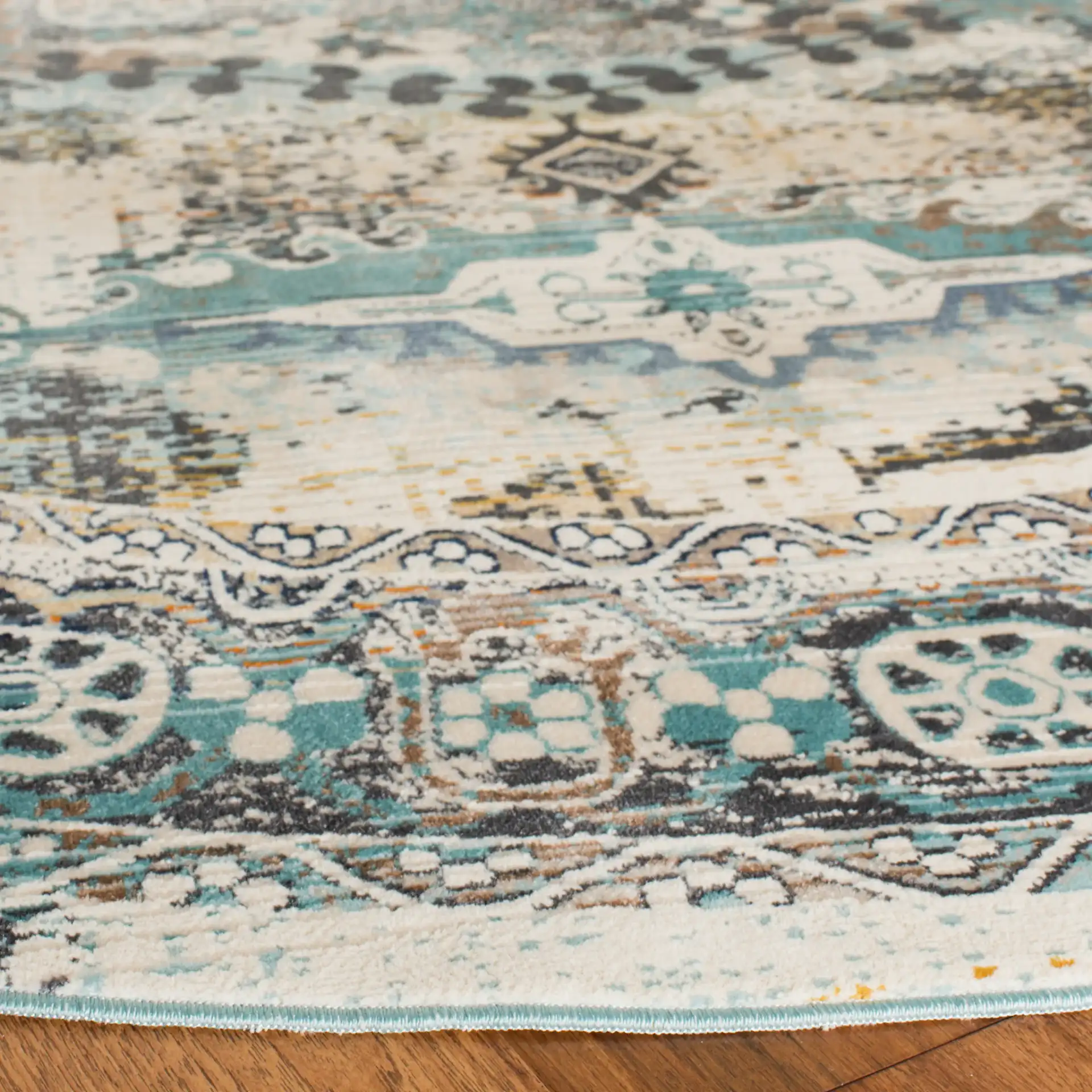 Baldwin Distressed Medallion Rug in Ivory / Teal in a styled room