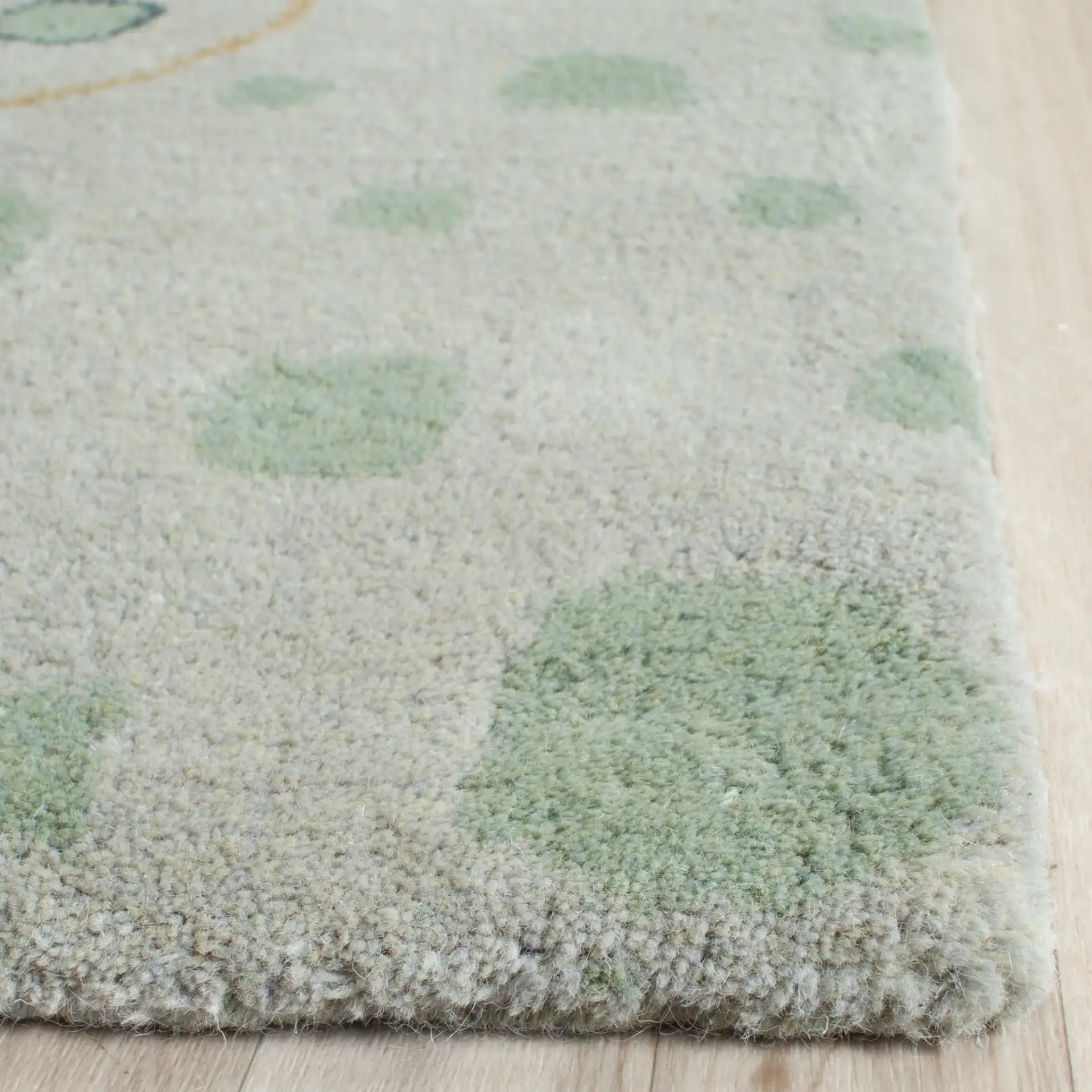 Bella Spiral Wave Hand-Tufted Wool Rug in Sage / Multicolor in a styled room