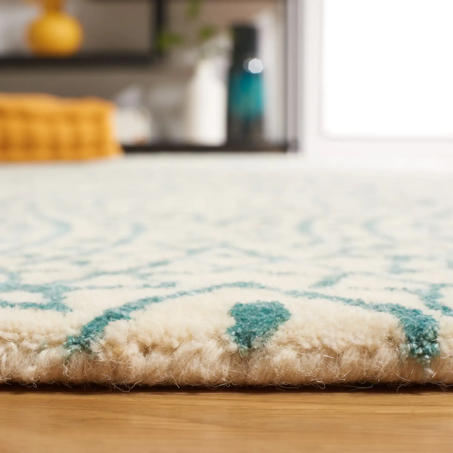 Bella Circular Medallion Hand-Tufted Rug in Ivory / Blue in a styled room