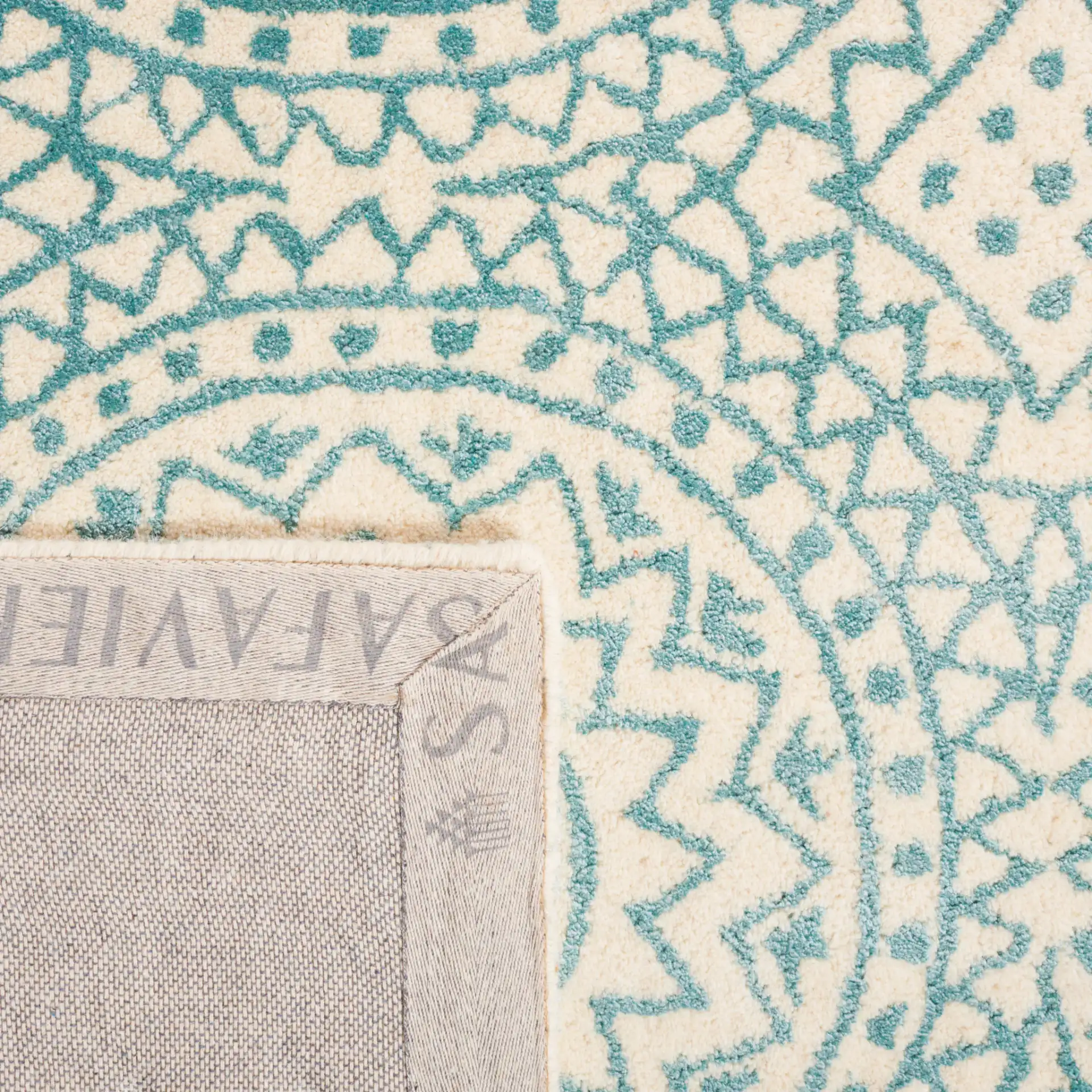 Bella Circular Medallion Hand-Tufted Rug in Ivory / Blue in a styled room