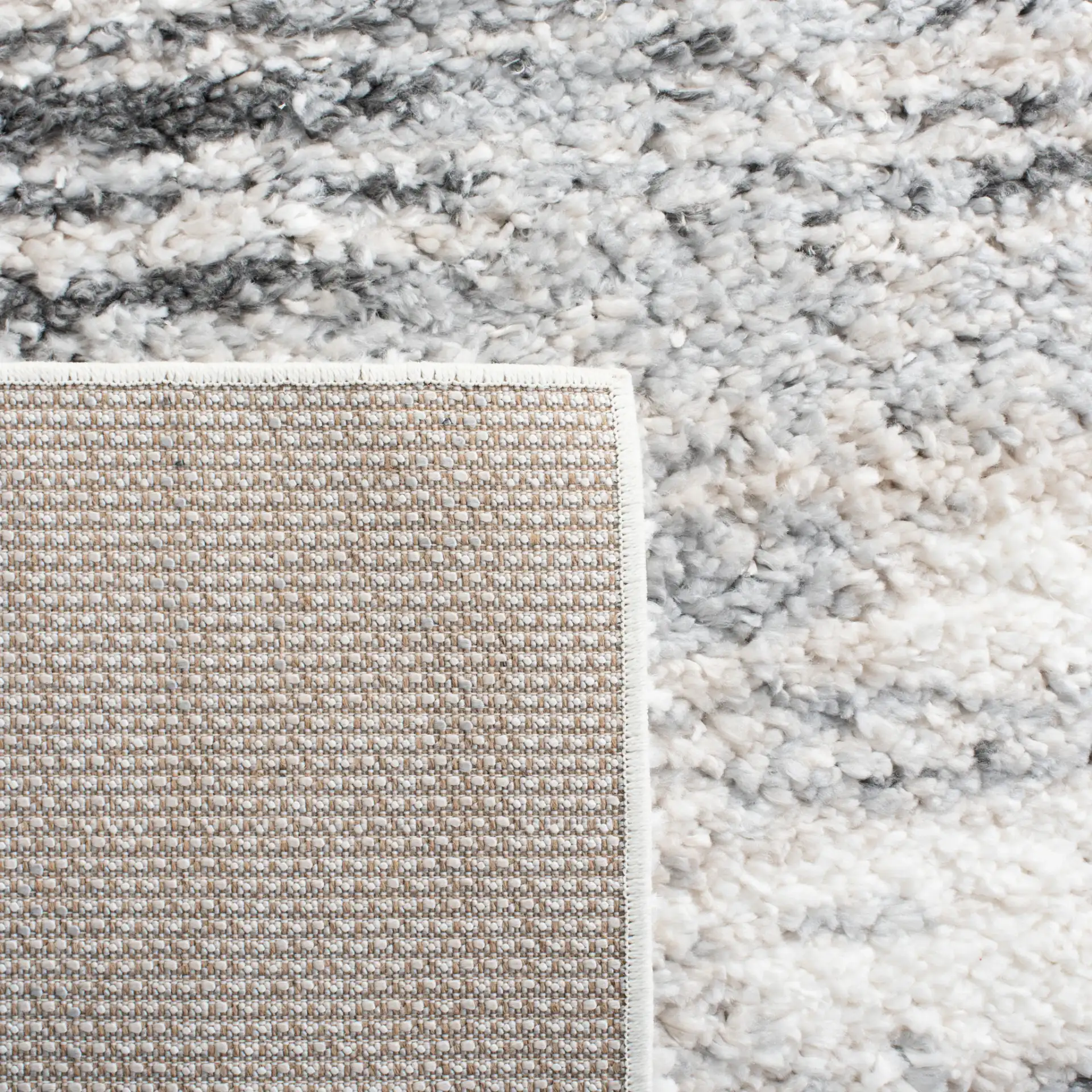 Berber Linear Stripe Shag Rug in Gray / Ivory in a styled room