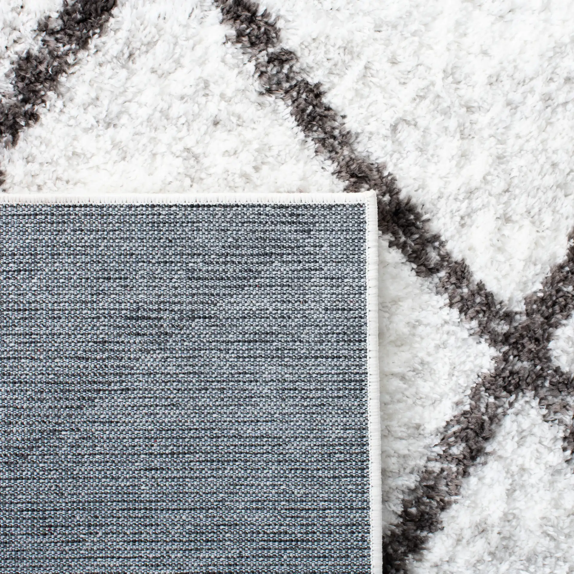Berber Oversized Diamond Trellis Shag Rug in Ivory / Gray in a styled room