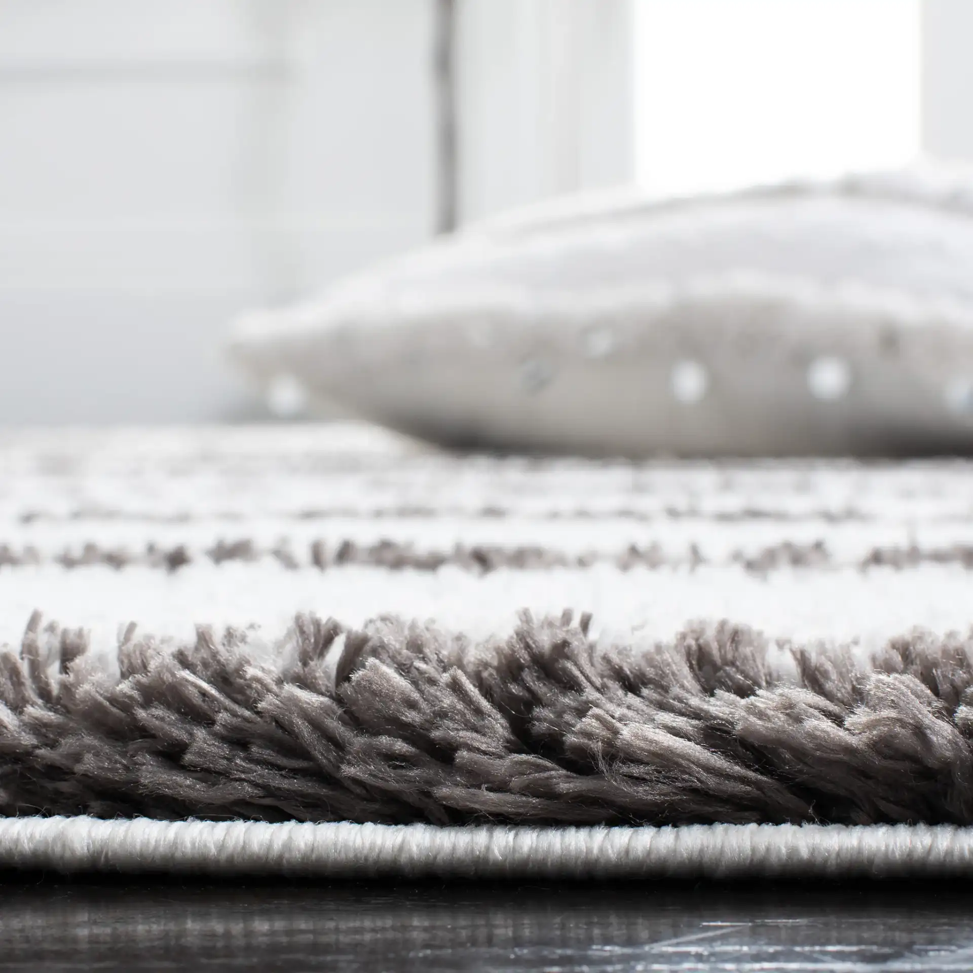 Berber Thin Horizontal Stripe Shag Rug in Ivory / Gray in a styled room