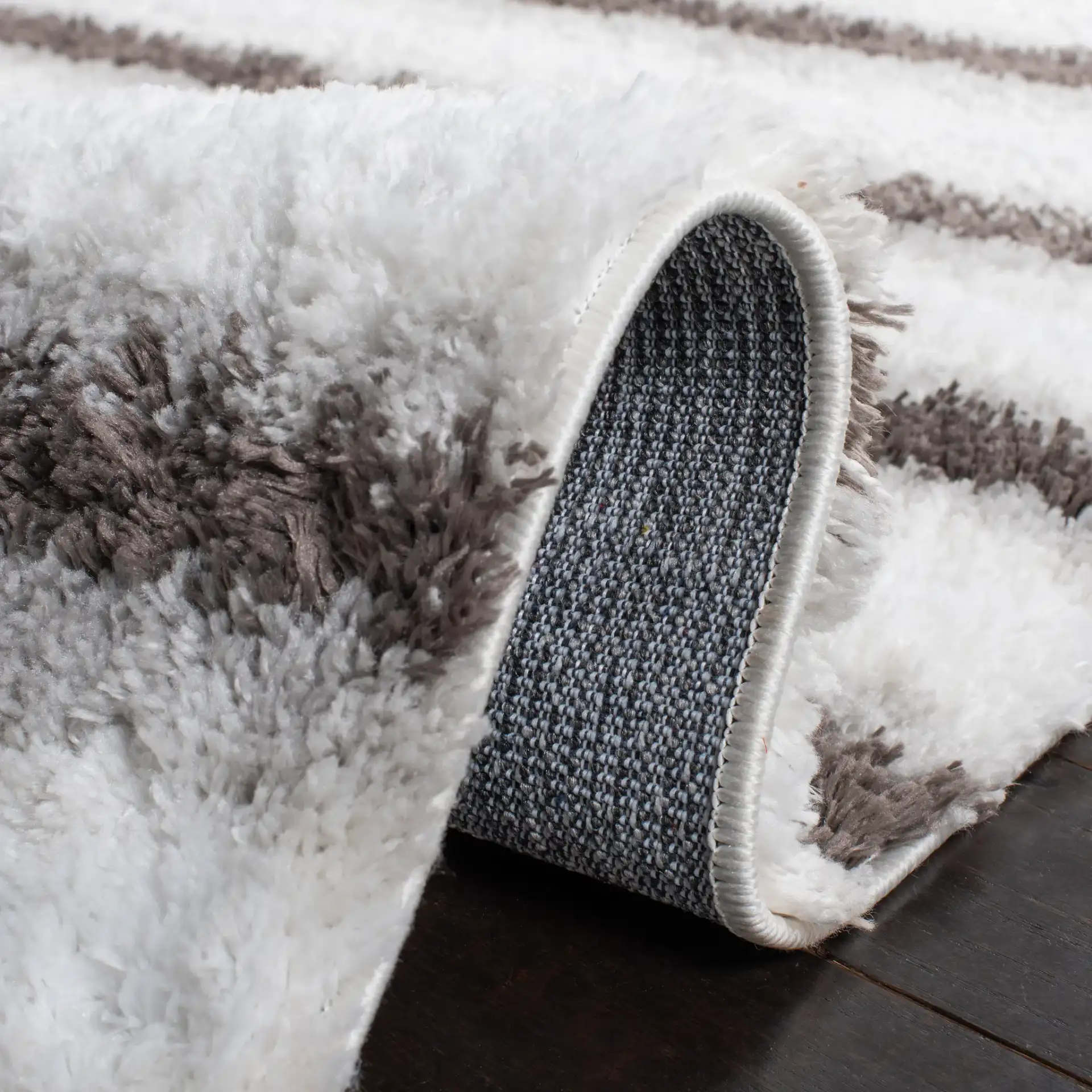 Berber Thin Horizontal Stripe Shag Rug in Ivory / Gray in a styled room