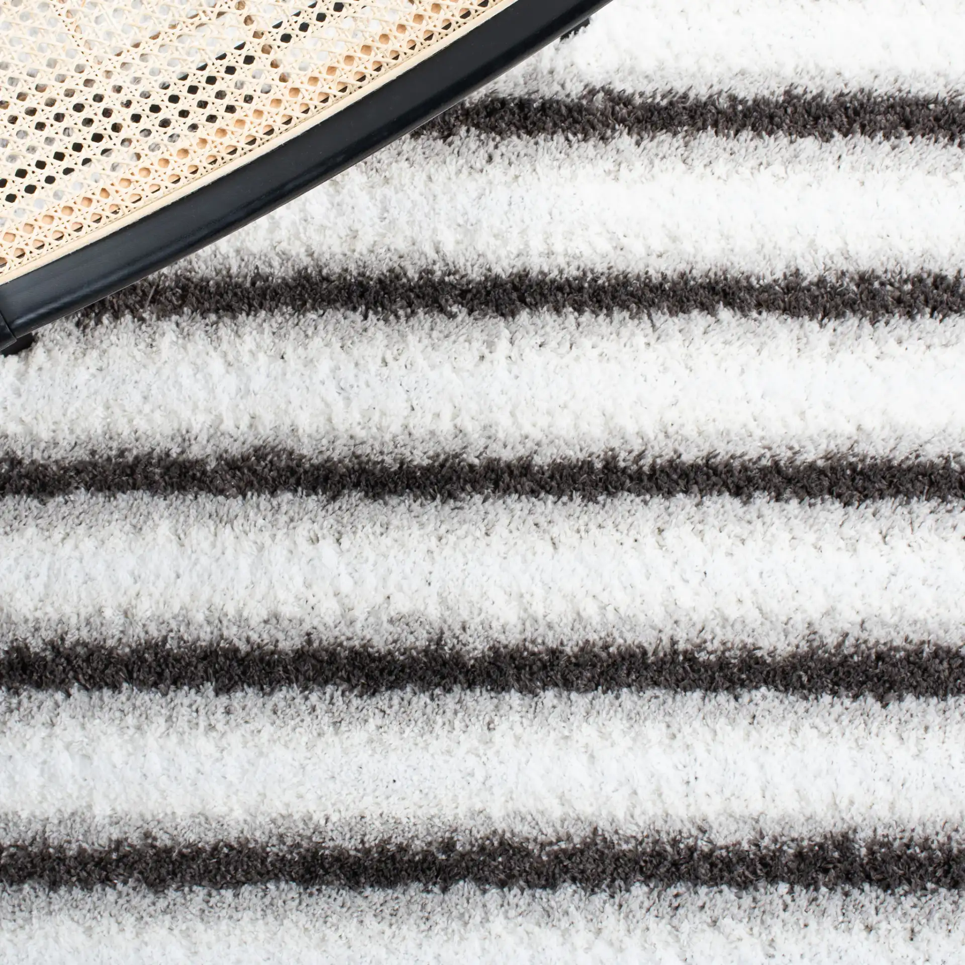 Berber Thin Horizontal Stripe Shag Rug in Ivory / Gray in a styled room
