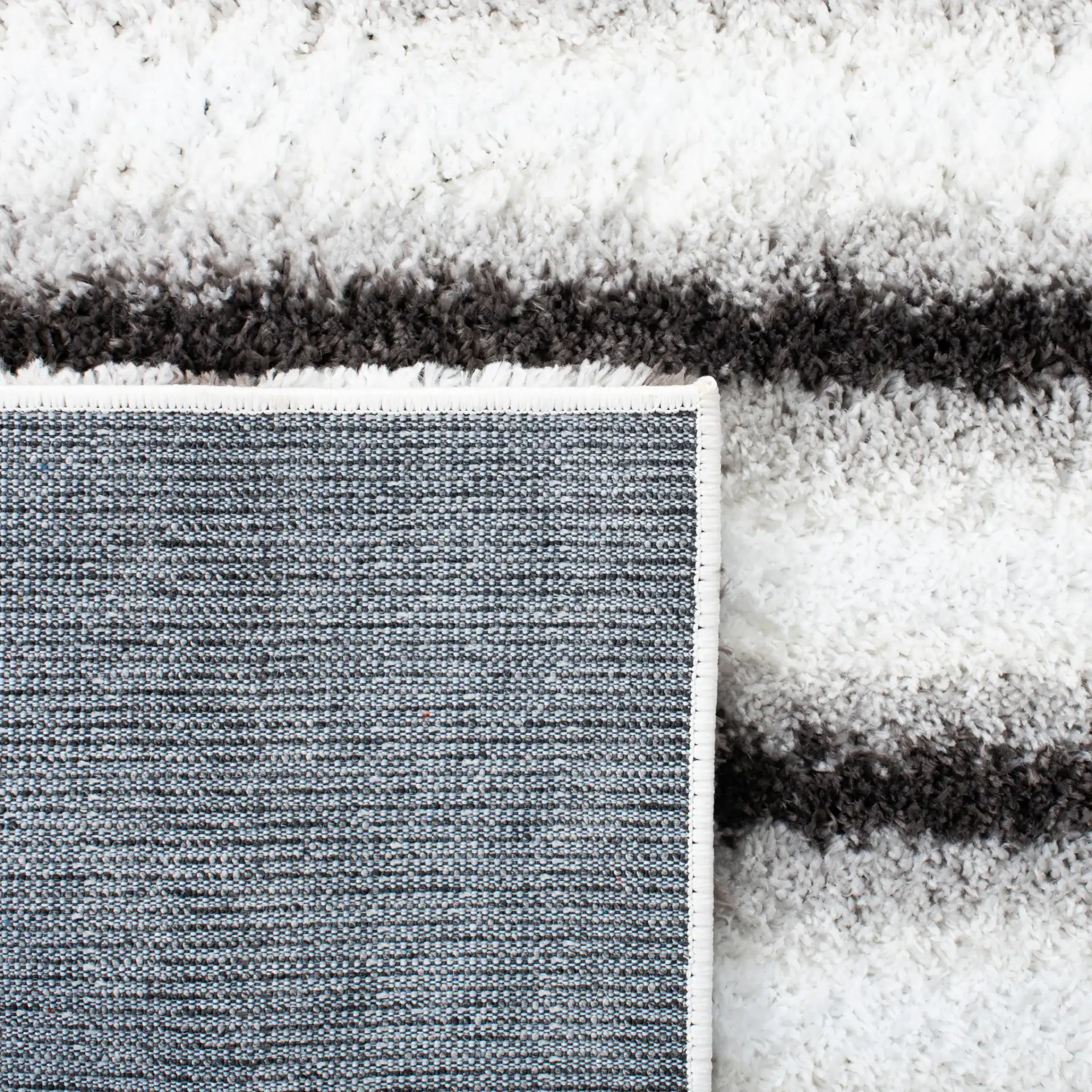 Berber Thin Horizontal Stripe Shag Rug in Ivory / Gray in a styled room