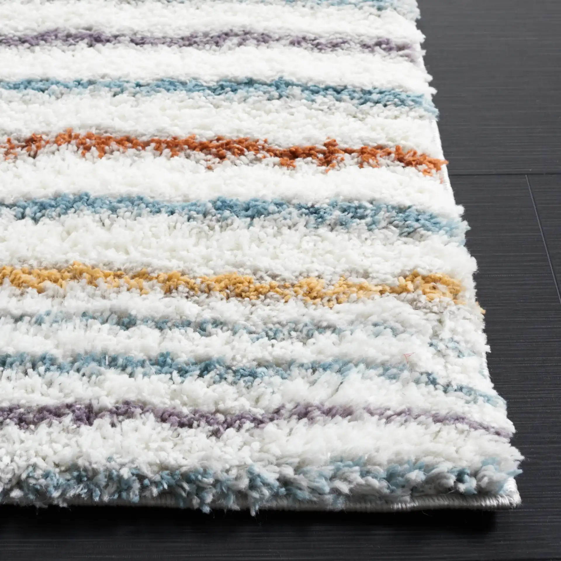 Berber Gradient Stripe Shag Rug in Blue Rust / Ivory in a styled room